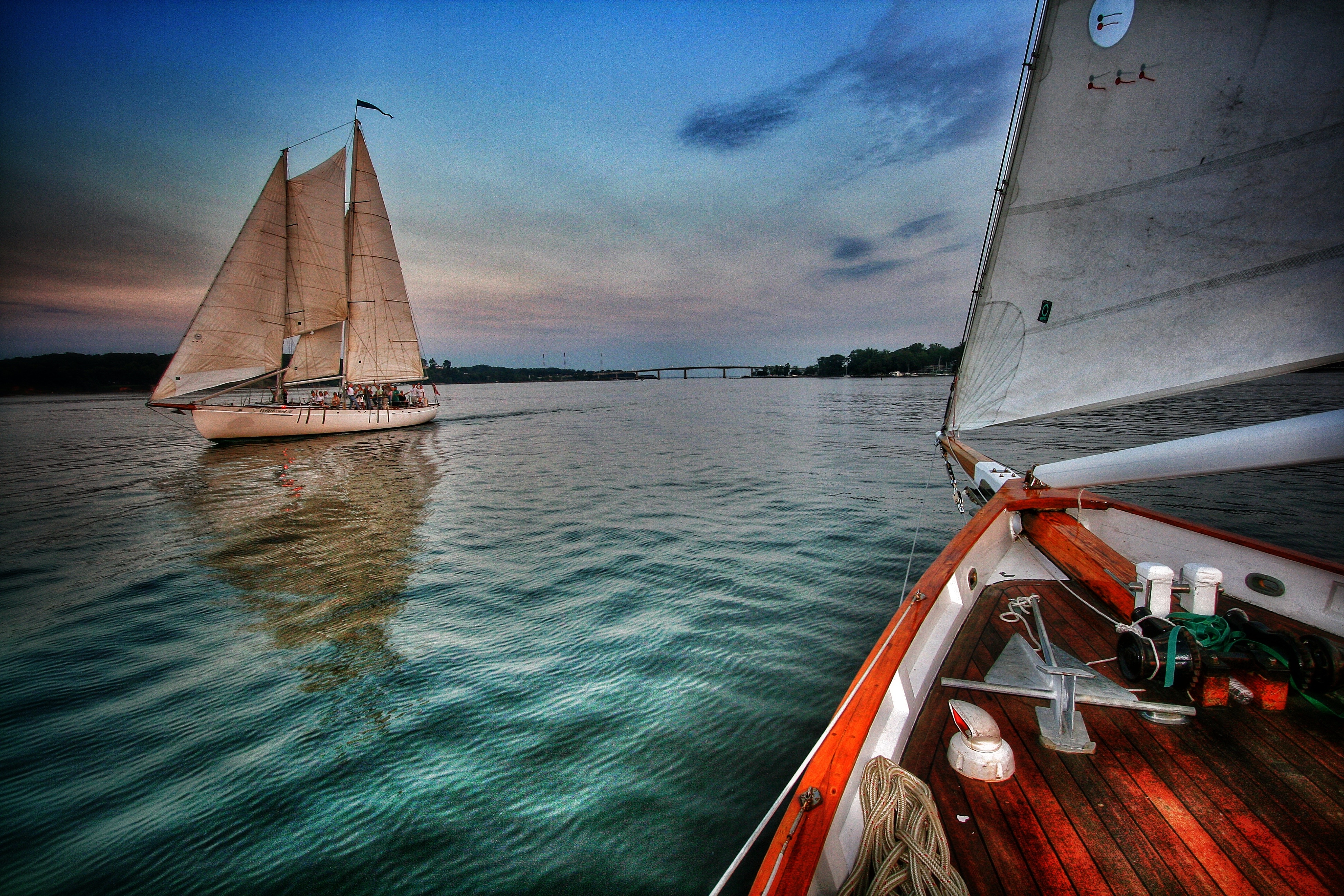 Rippled green waters and sunset sky with both schooners