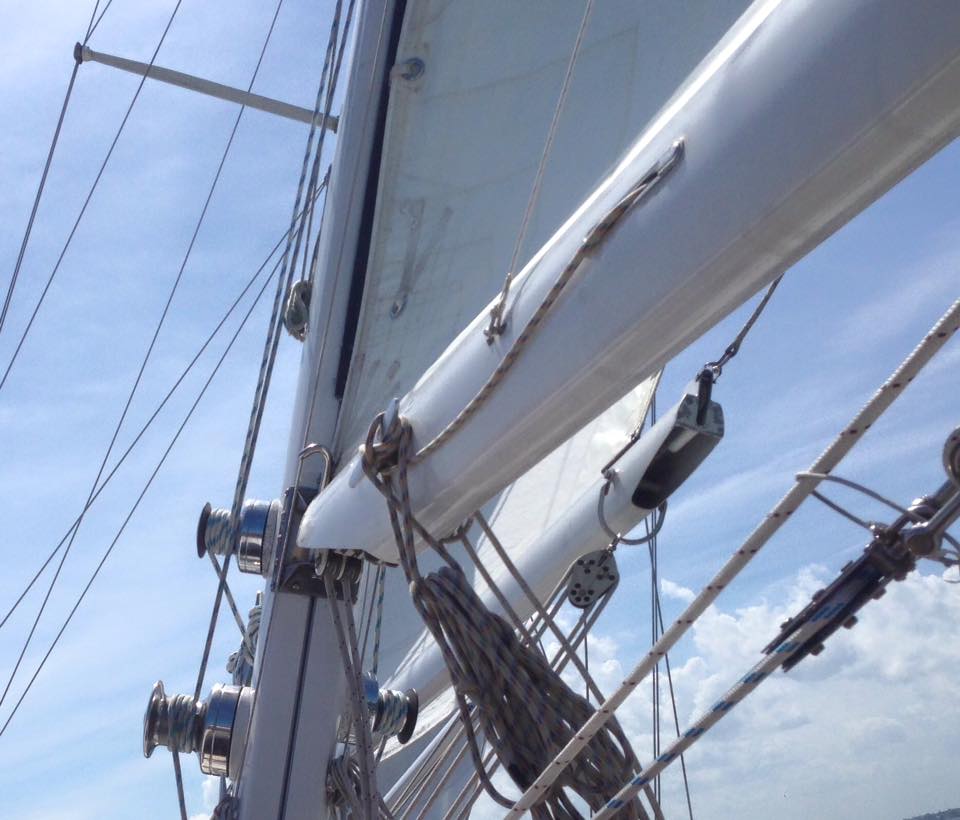 Sails and rigging under a light blue sky