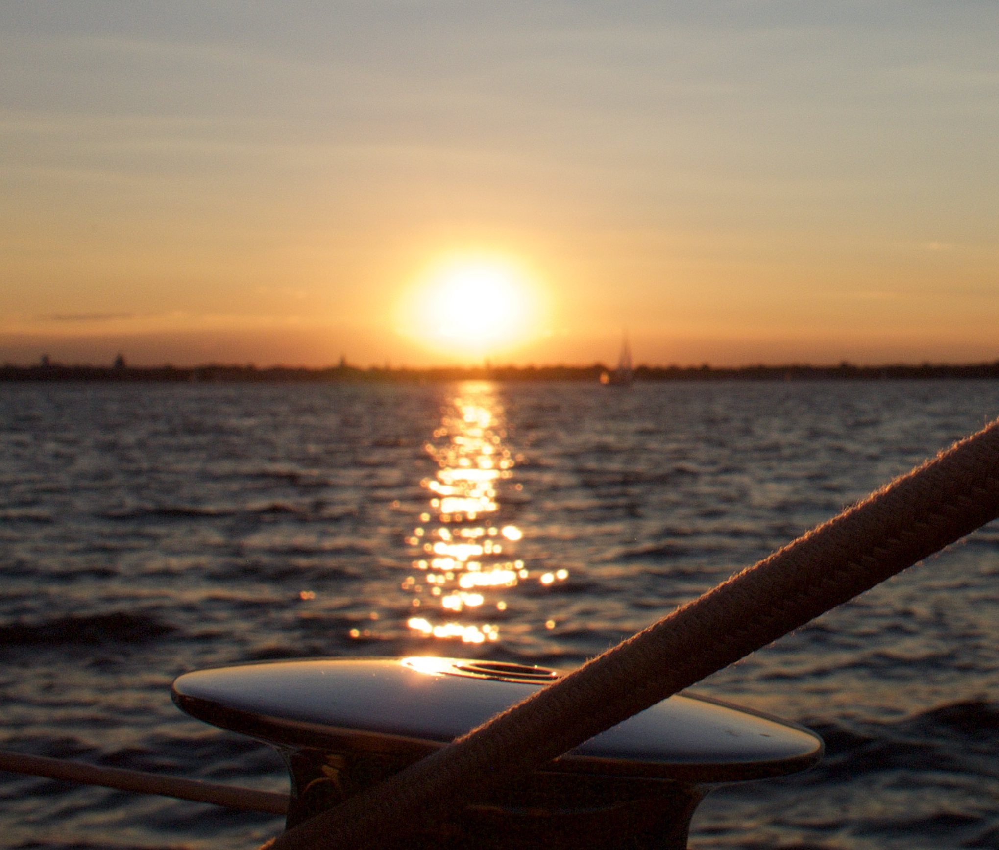 The winch on the schooner shinning in the golden sunset