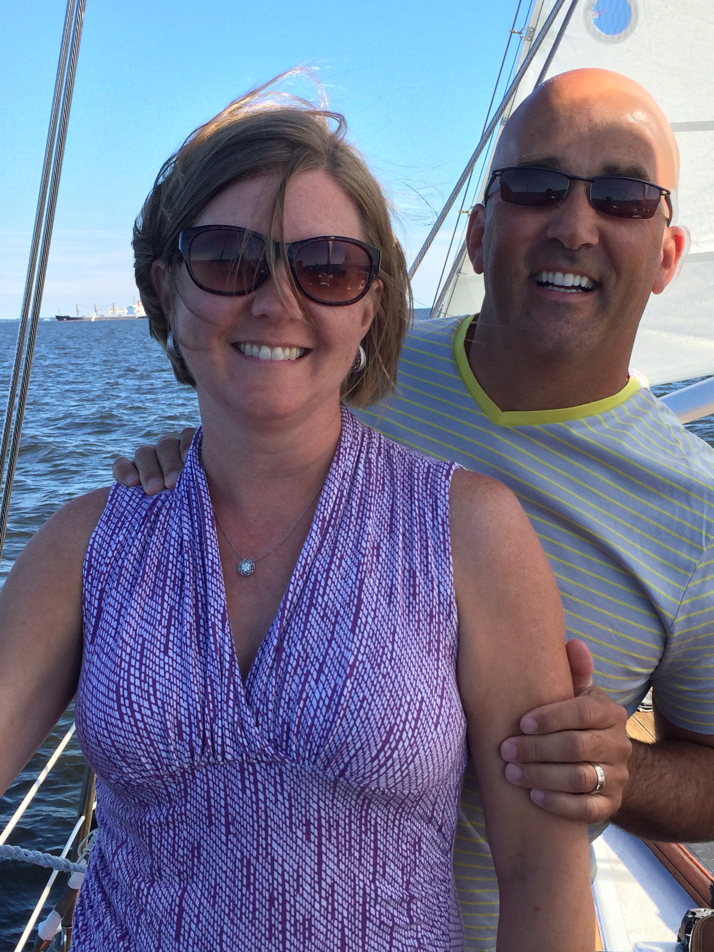 Couple smiling and having fun on a schooner sail