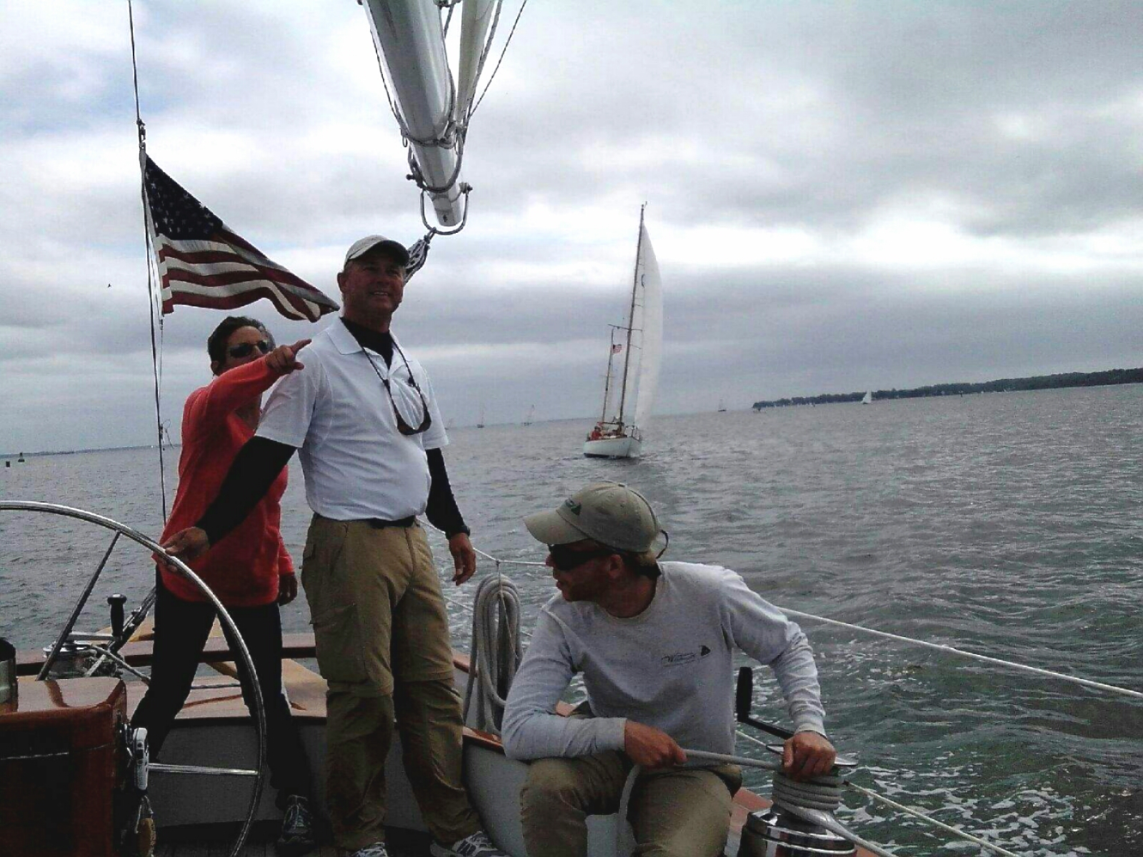 Captains on schooner working together with crew to win a race