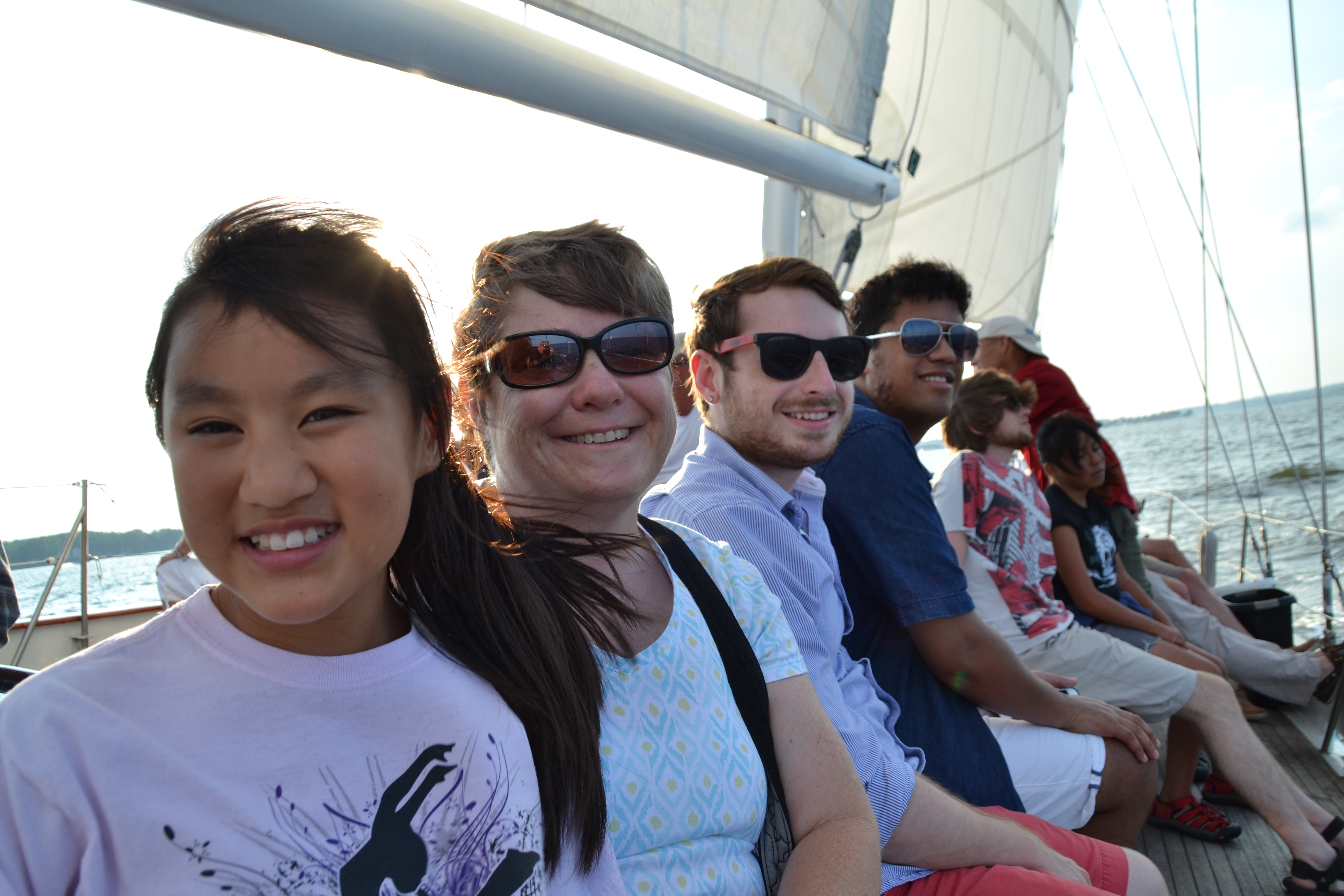 Guests all smiling on a sail on the Chesapeake Bay