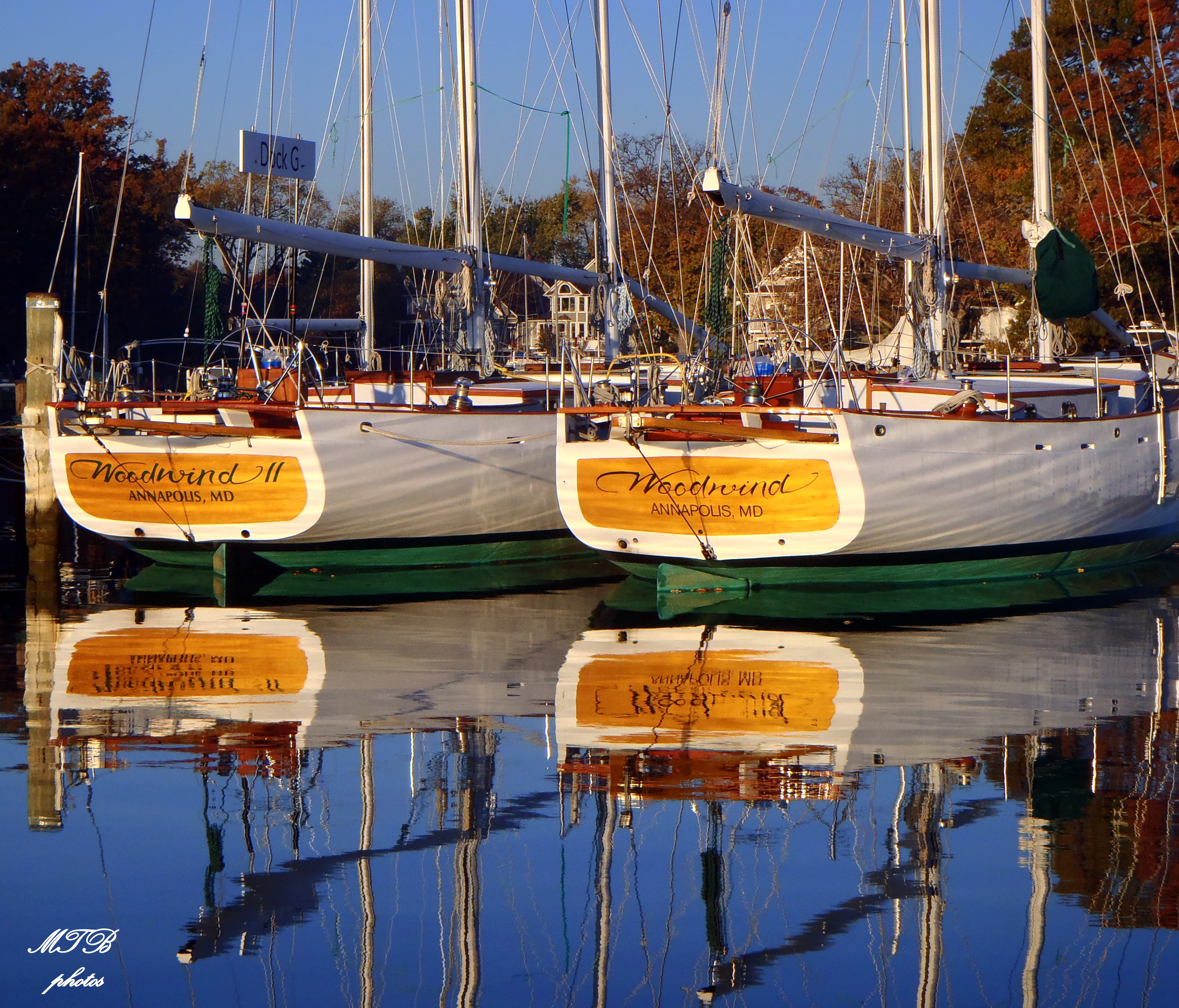Two Woodwind Schooners side by side docked and reflecting in water