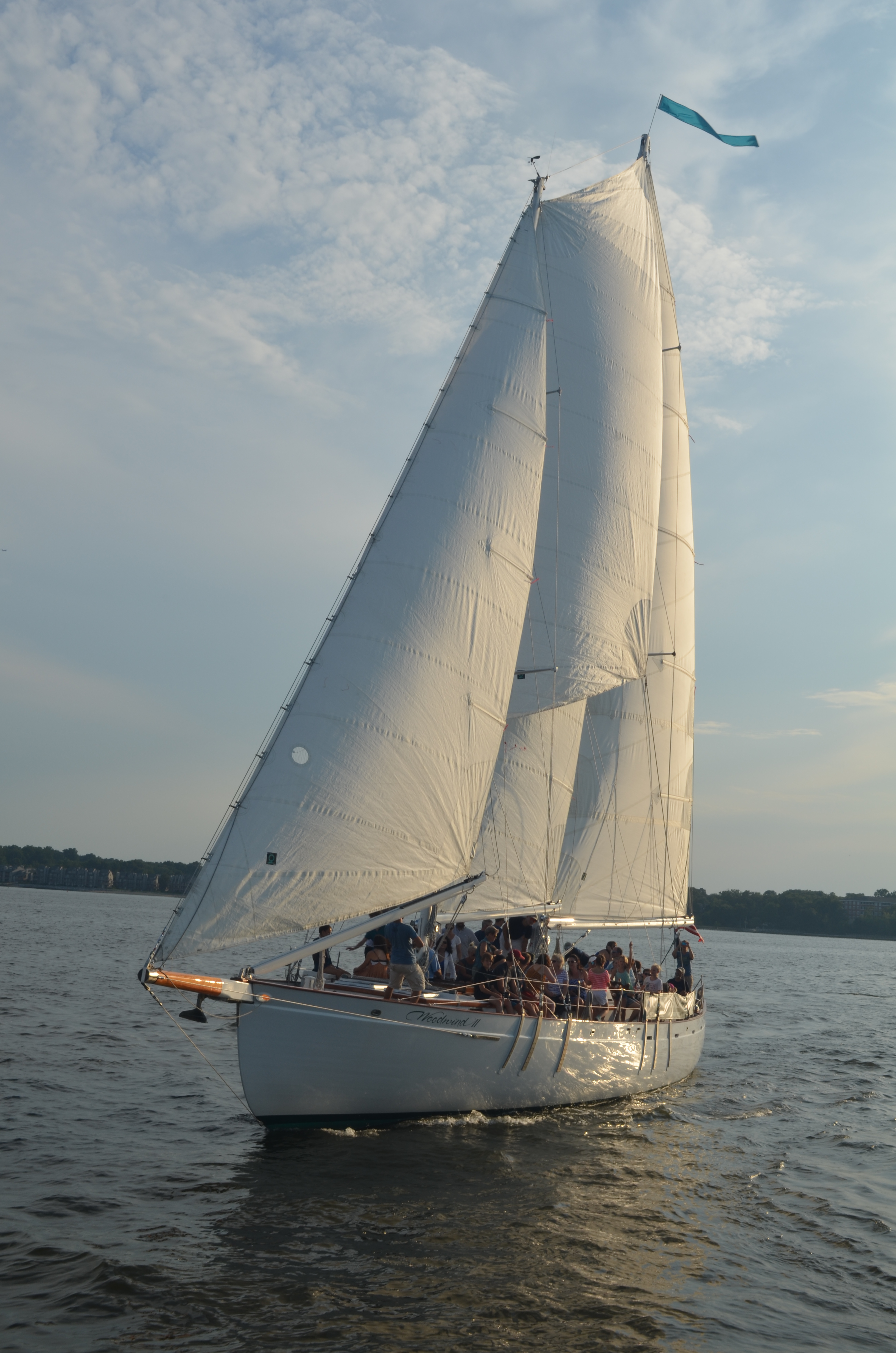 Schooner sailing with guests aboard on a sunny day