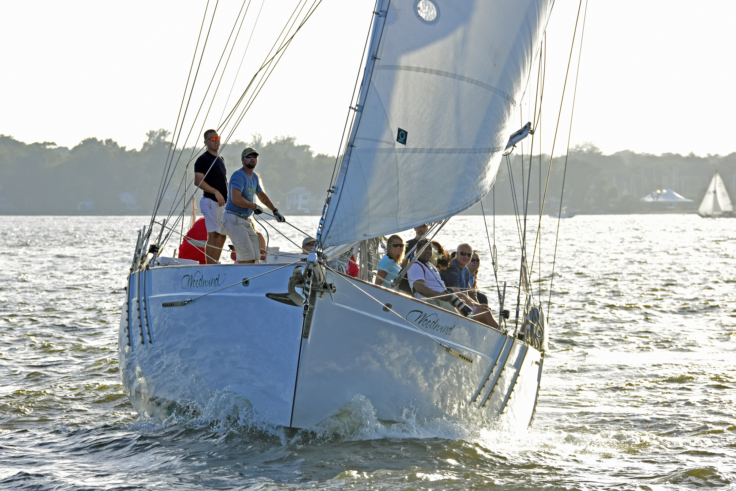 Guests and crew on schooner flying over the water sailing