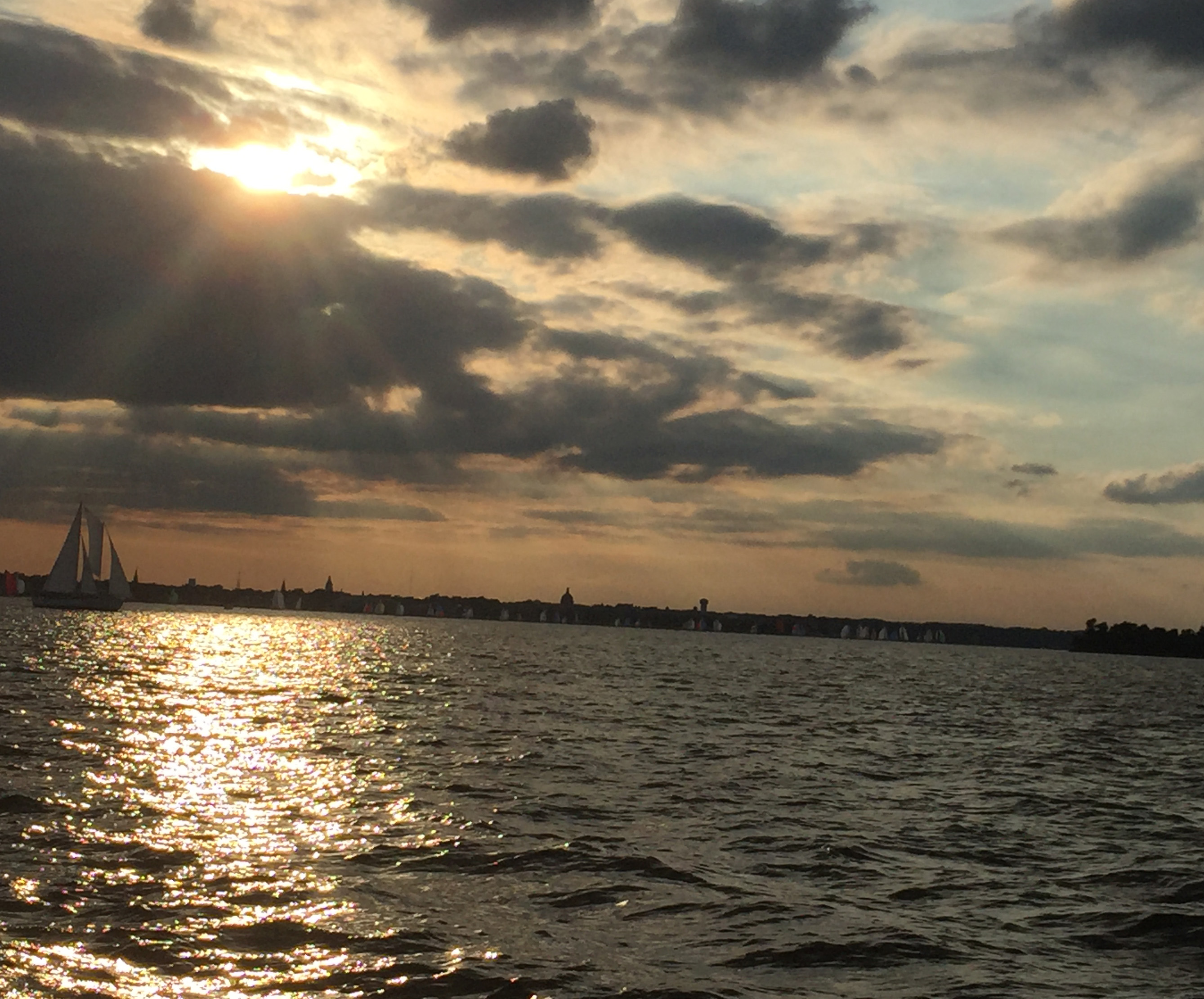 Sunset with rays of sun peaking through clouds over Annapolis