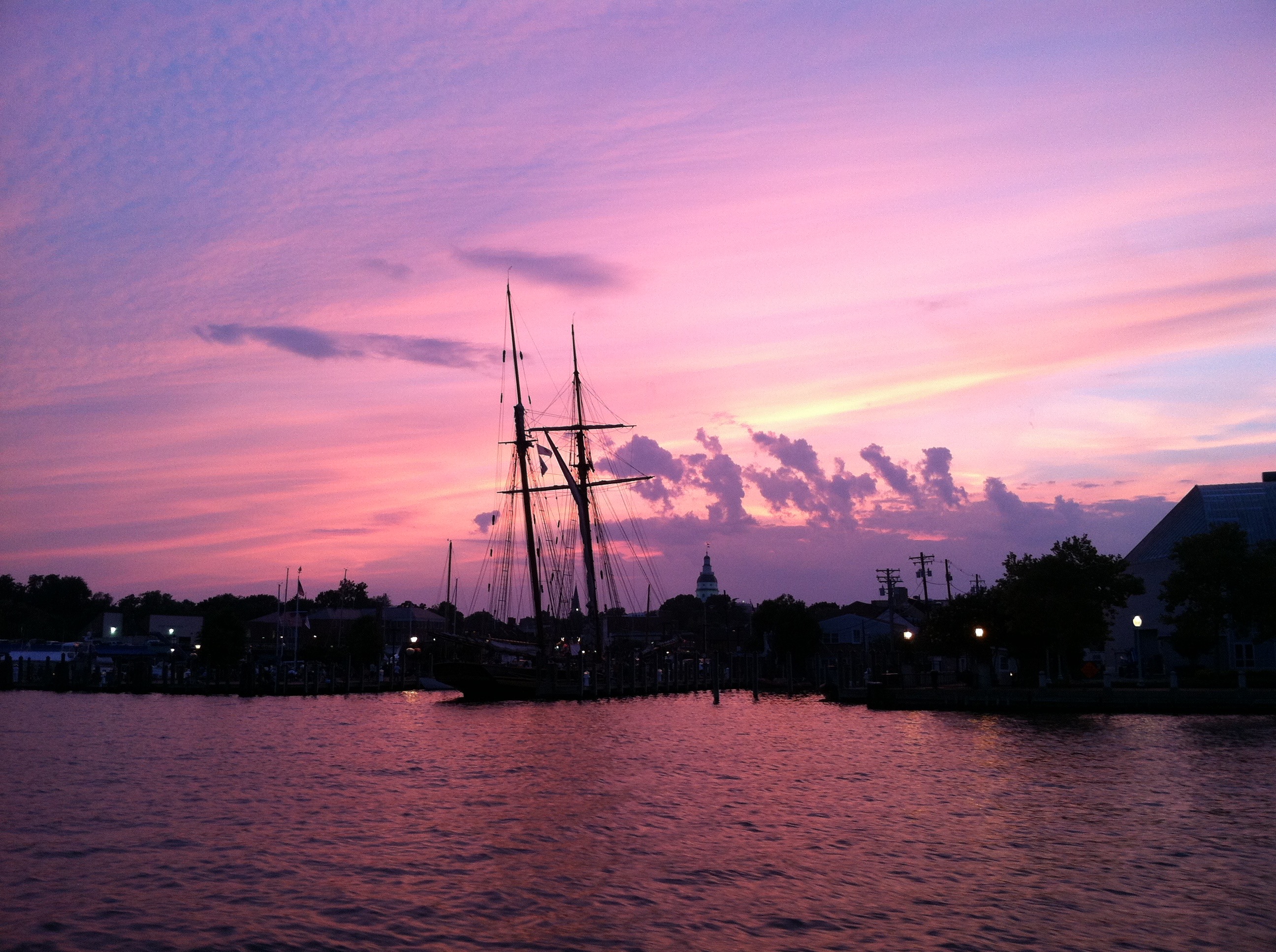 Annapolis skyline and water turned purple in sunset and silhouetting masts