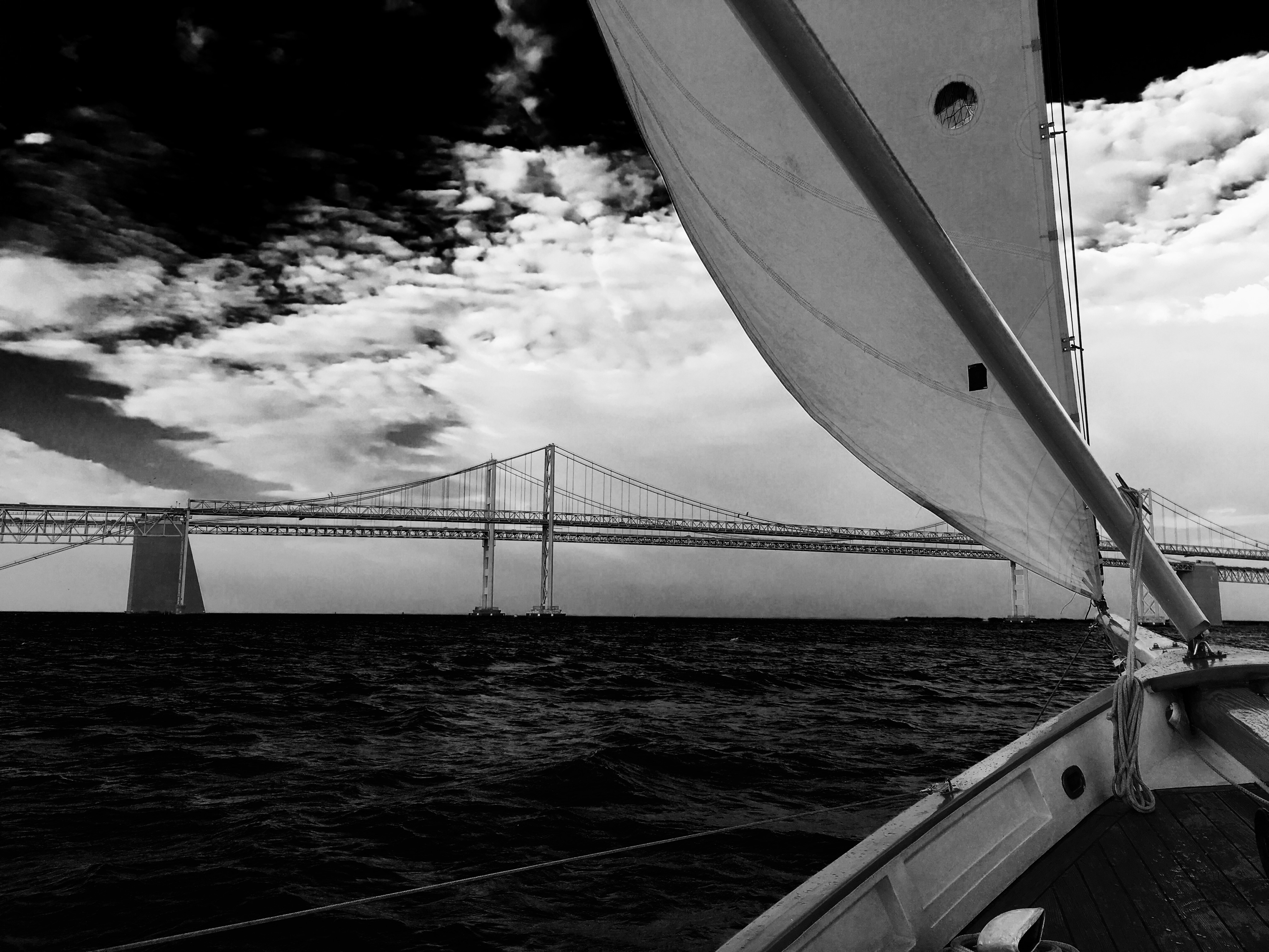 Black and white photo from stern of schooner with Bay Bridge