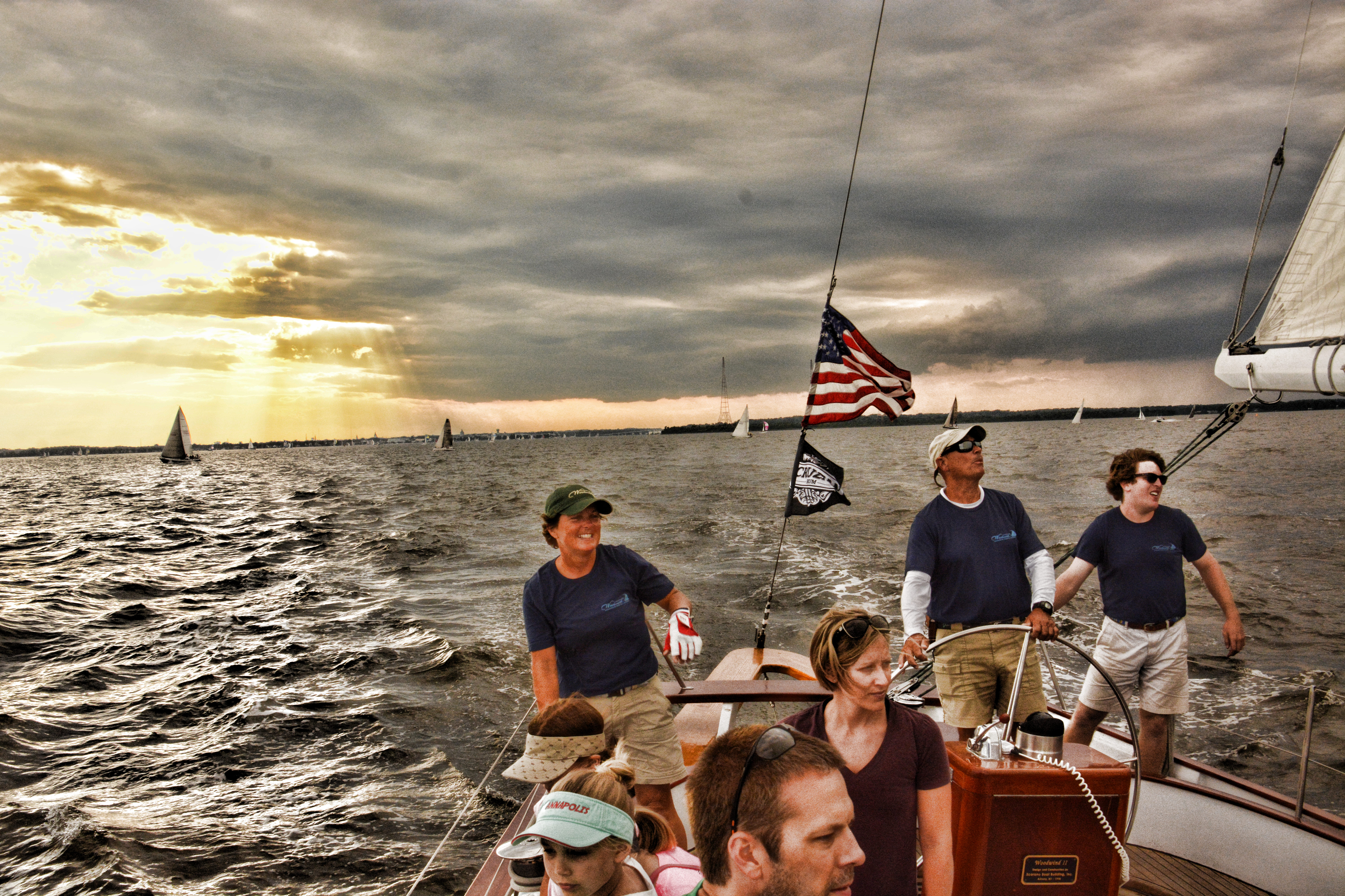 Sailing captain and crew with dramatic sky and waters around them