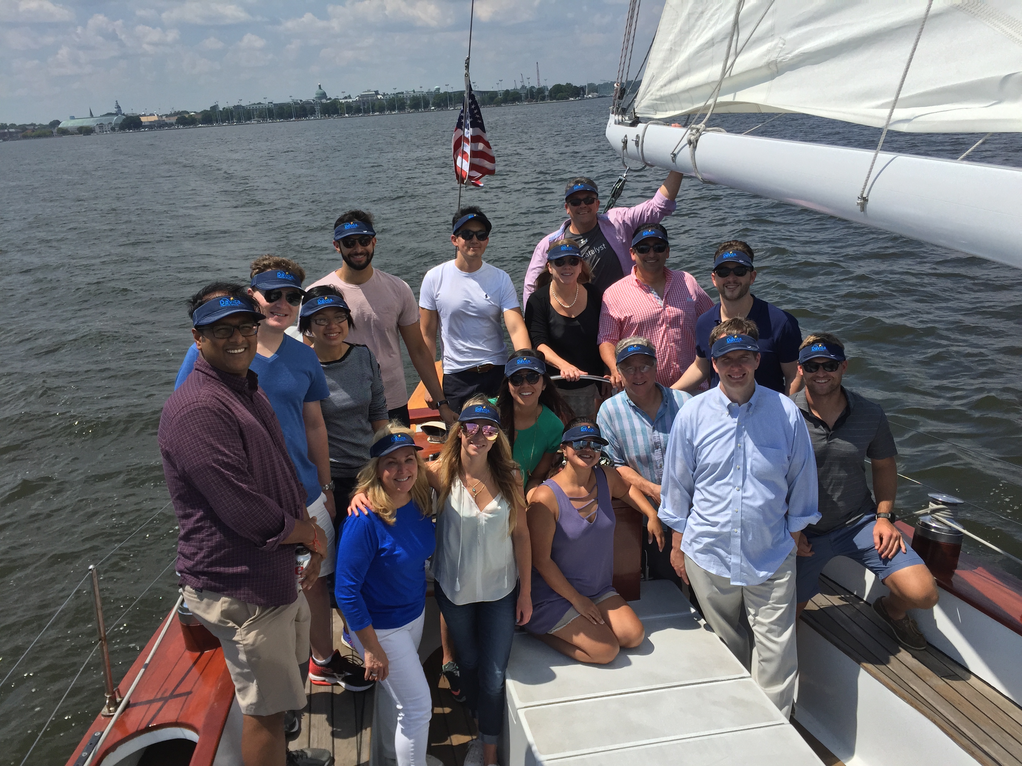 Company outing picture all have on black visors with blue print