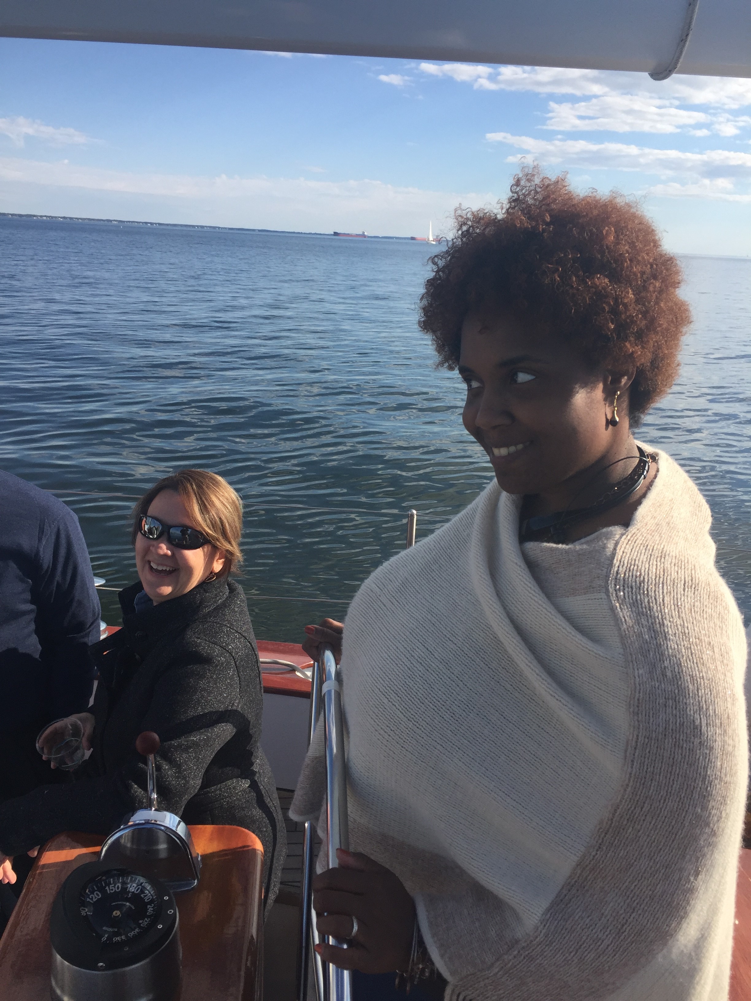 Women looking unsure about steering the big schooner with a smile