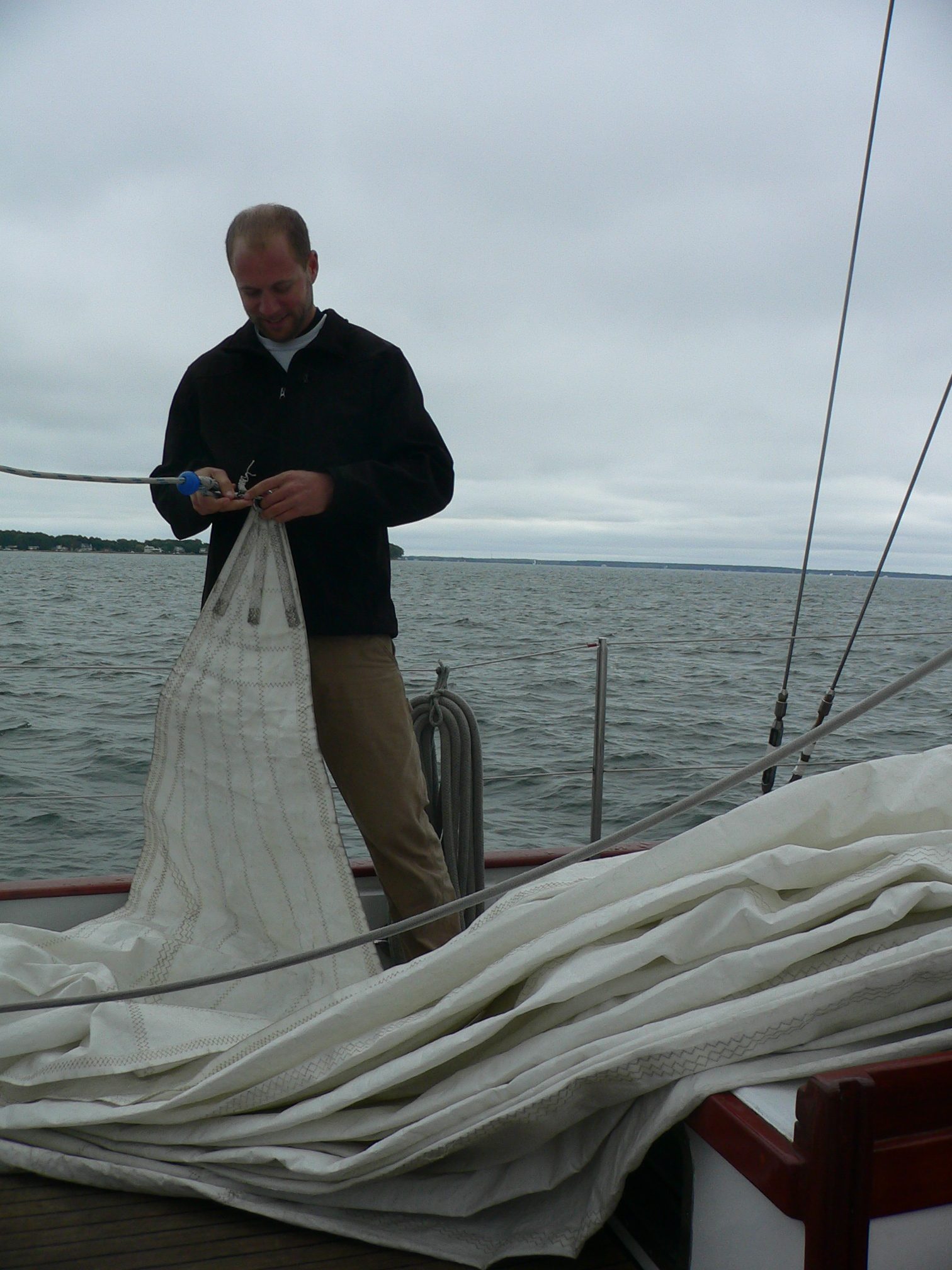 Crew member working on sail