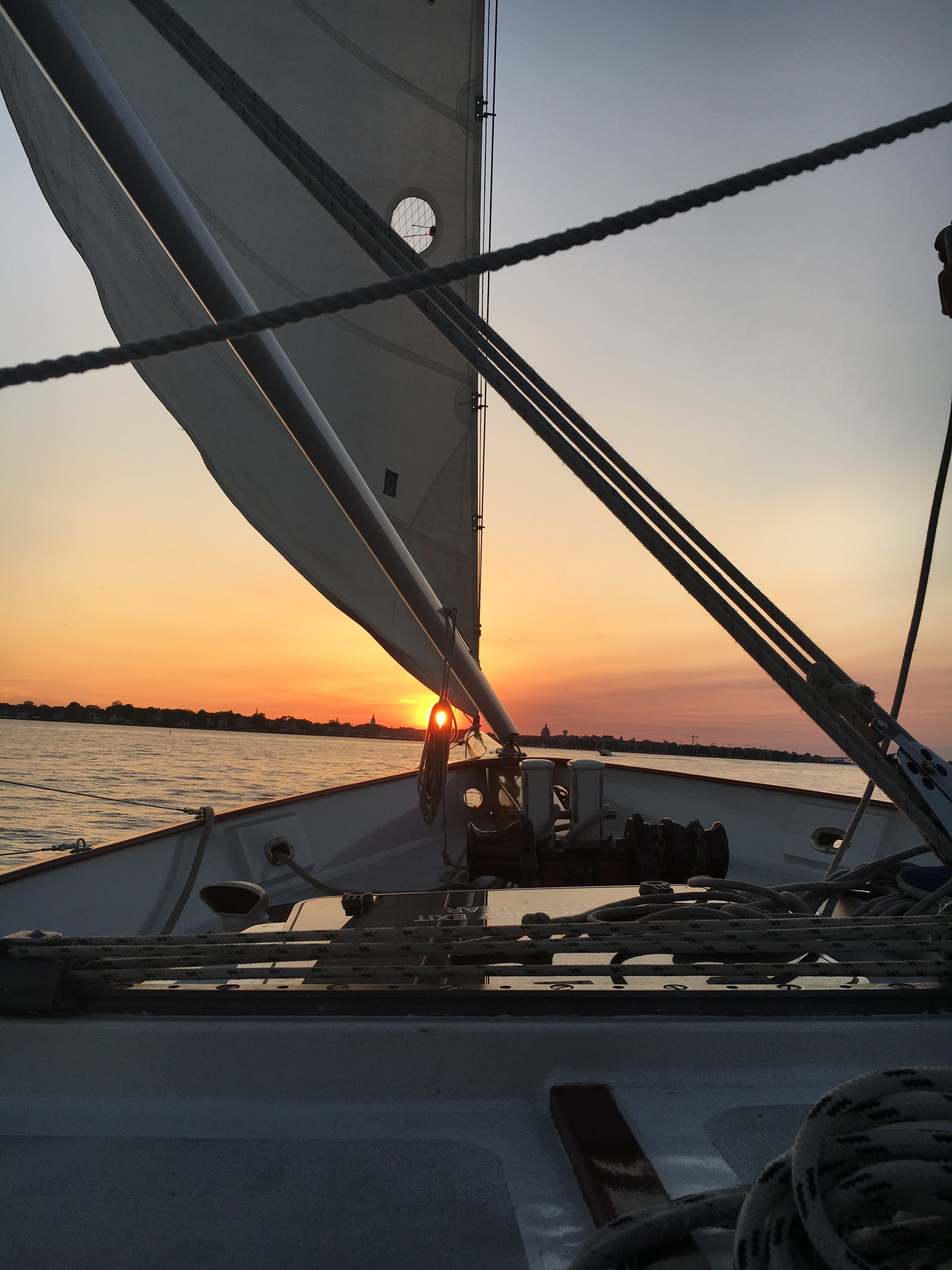 View from on board the schooner sailing straight at the setting sun