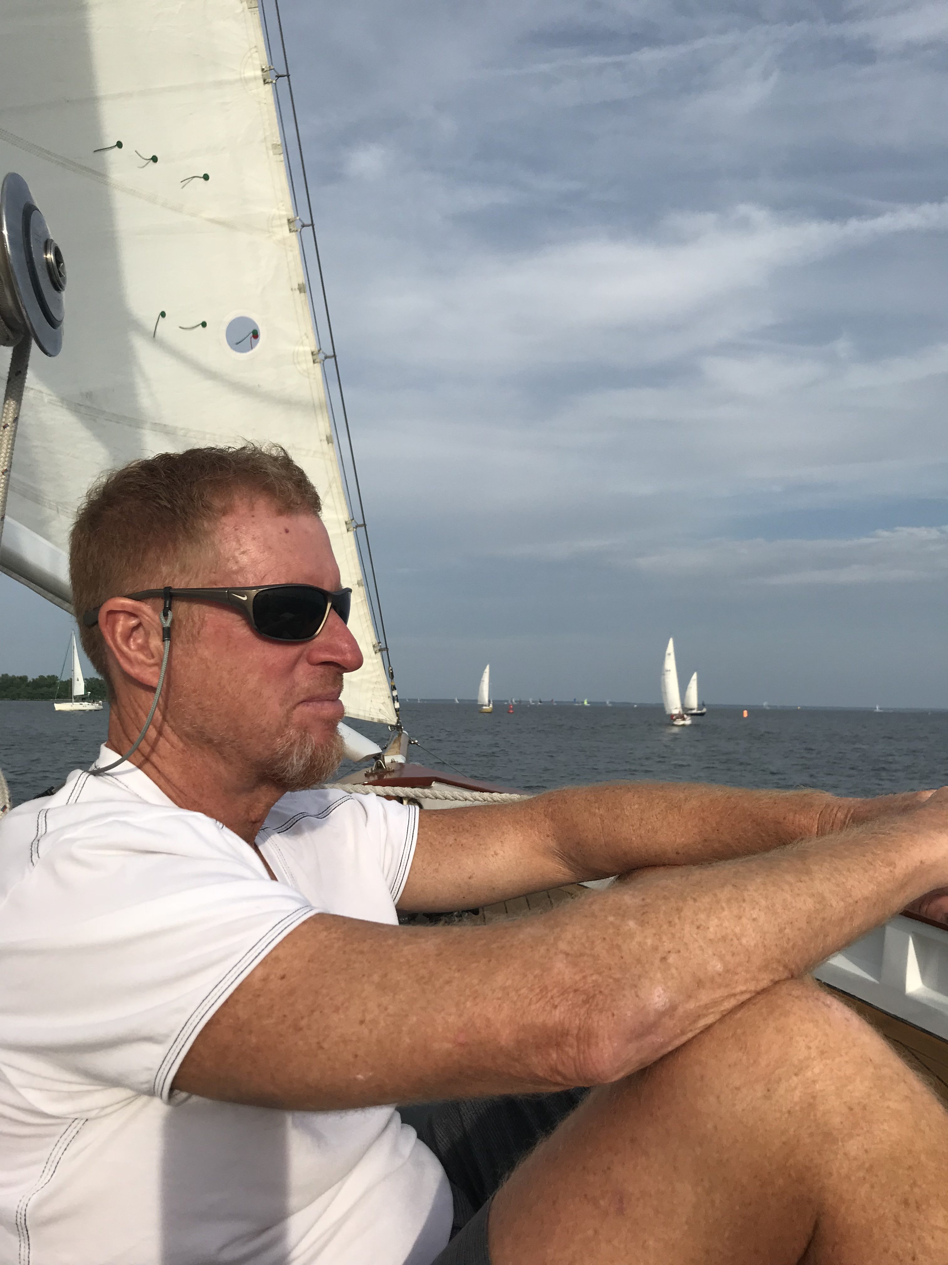 Man sitting on board and looking out over the water