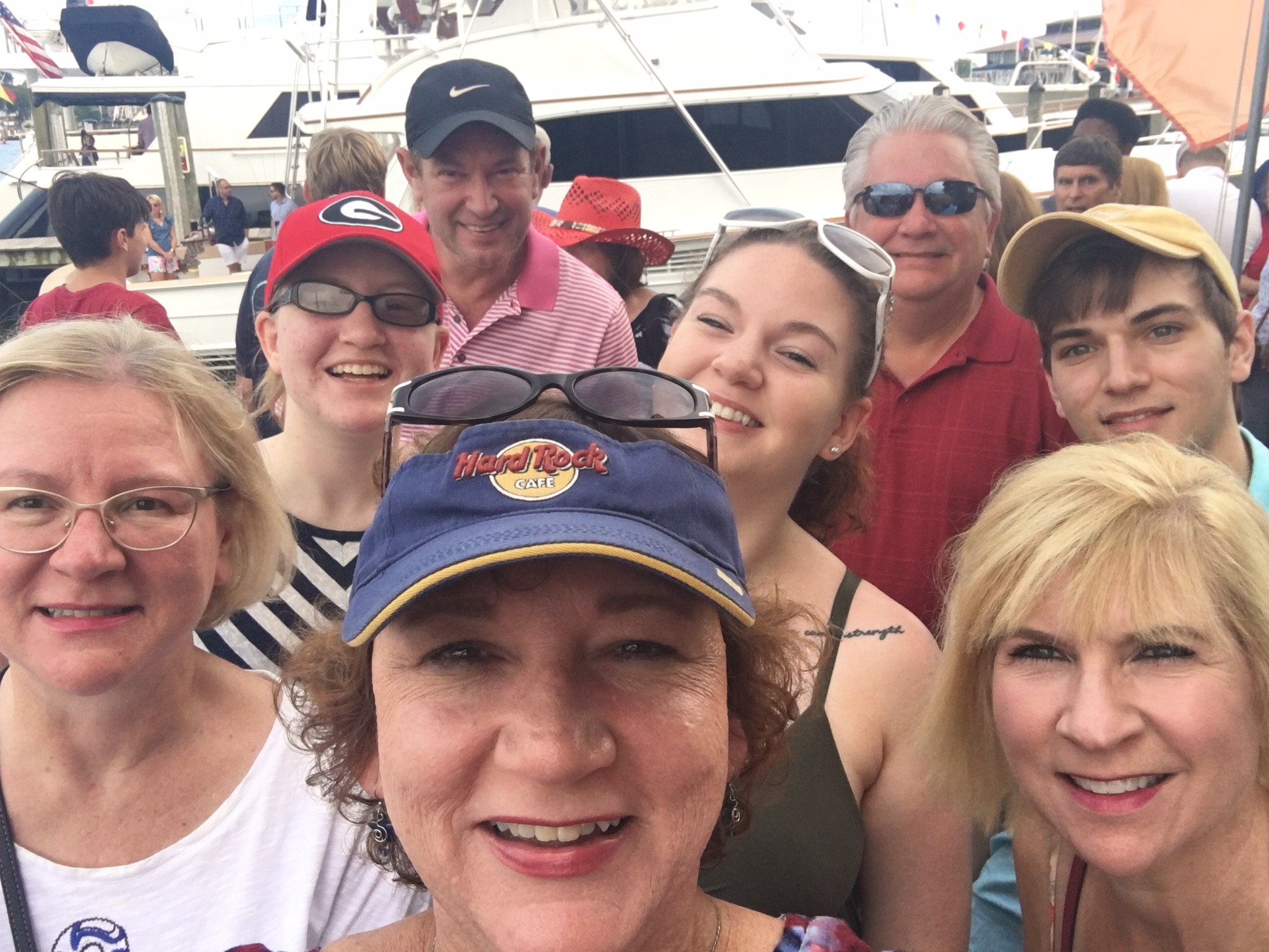 Large group of people anticipating their sail as they wait on the dock