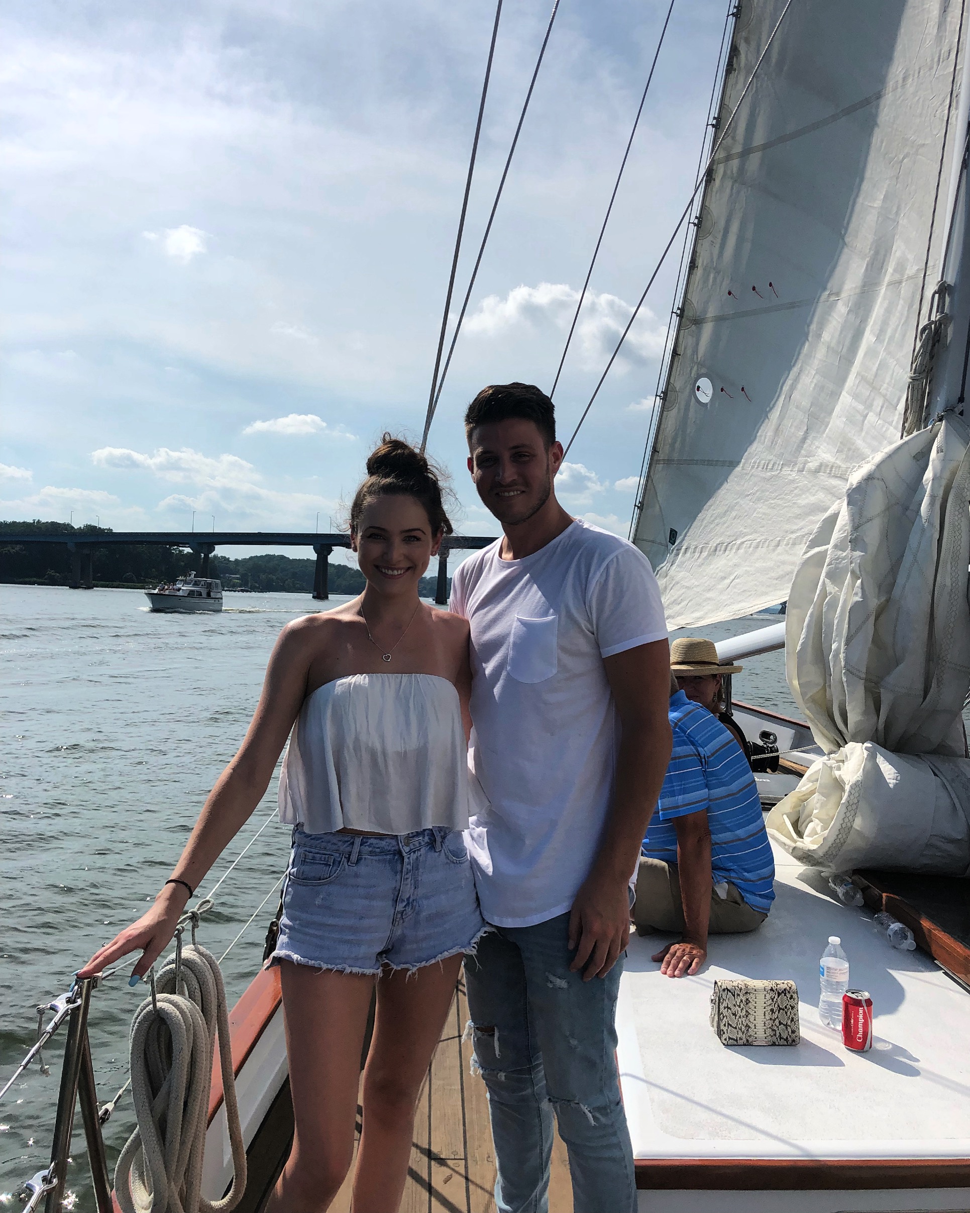 Young couple sailing on sunny summer day