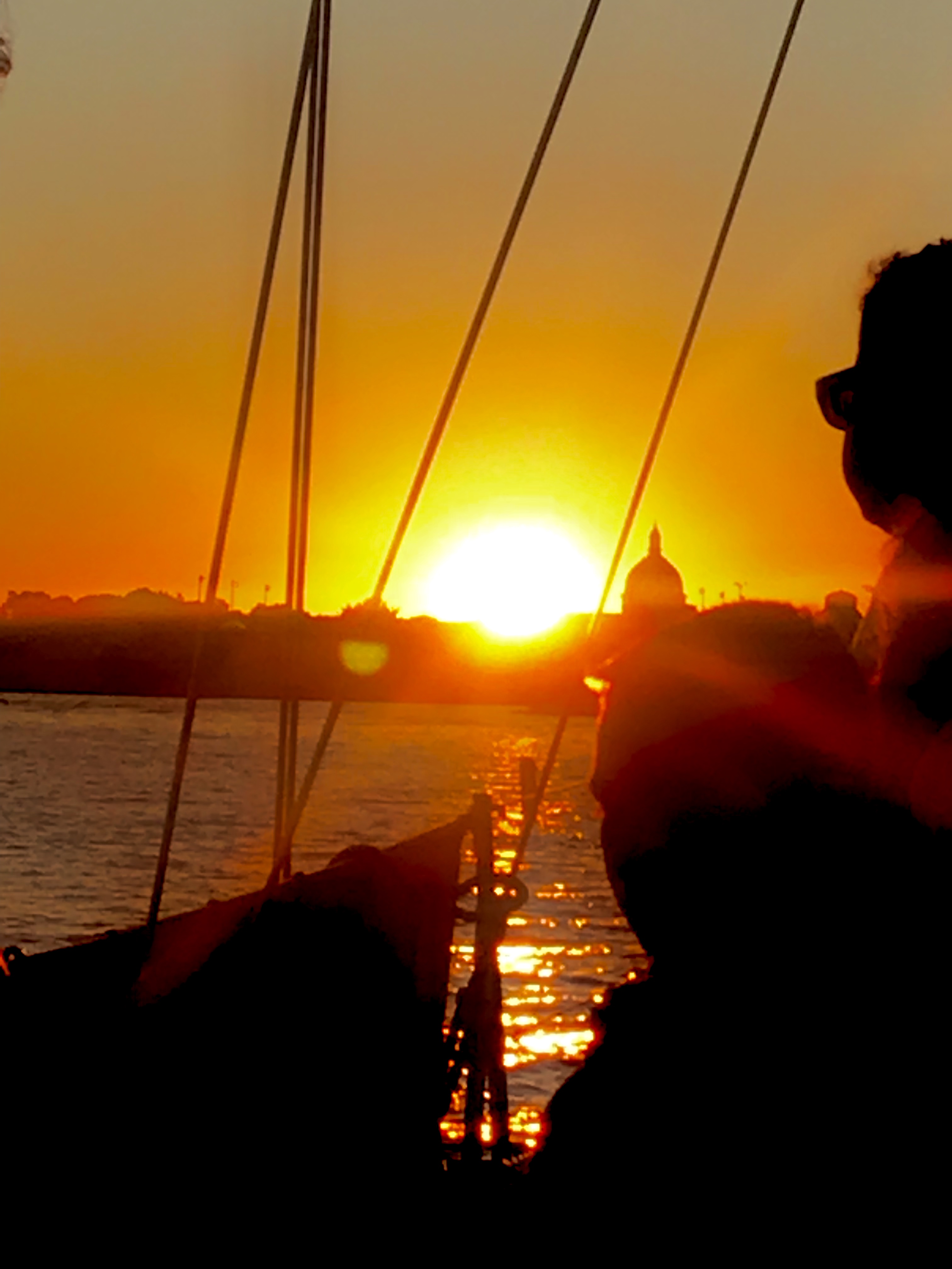 Bright sunset framed between the rigging lines