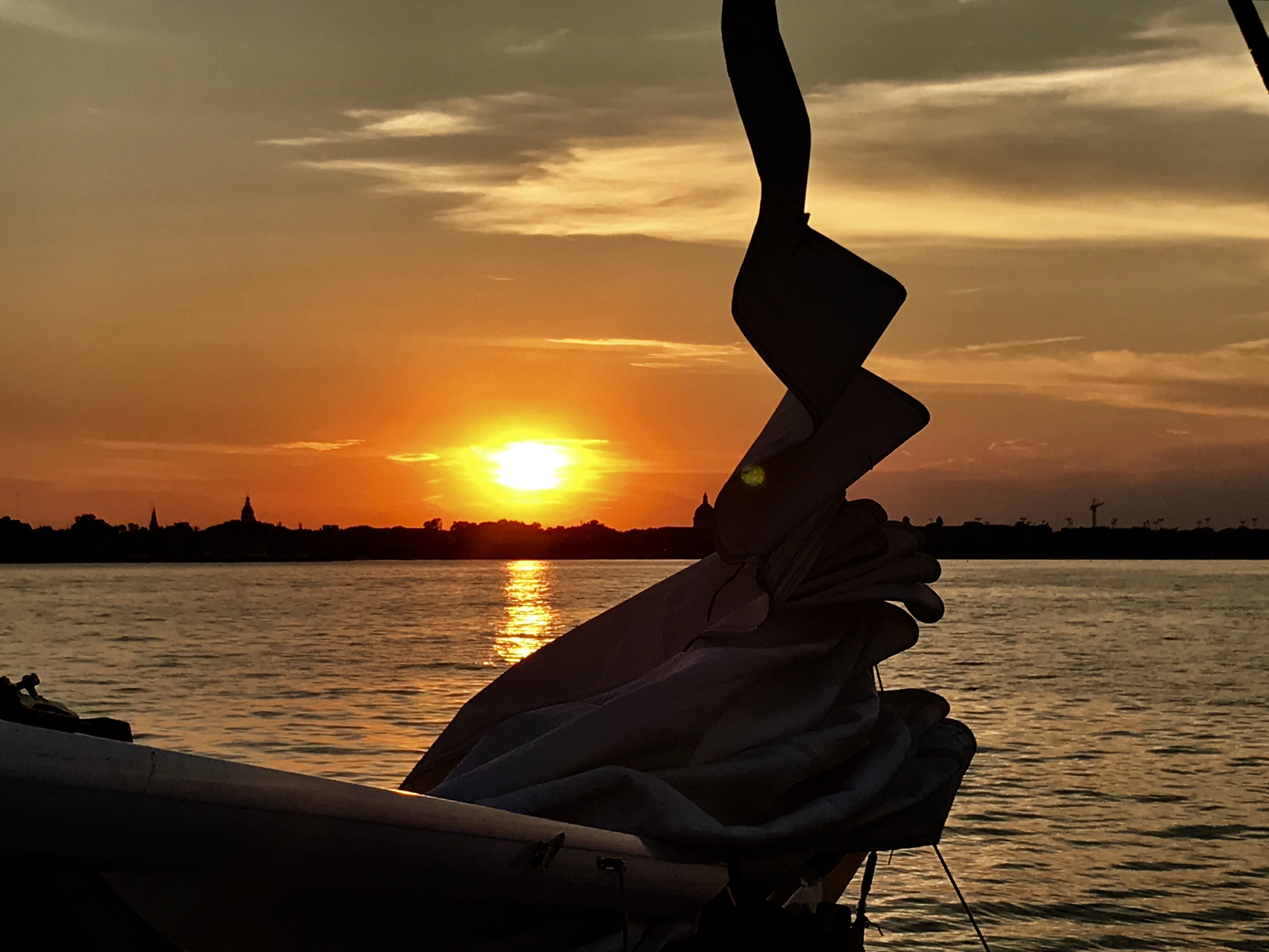 Sails coming down at the end of sunset sail