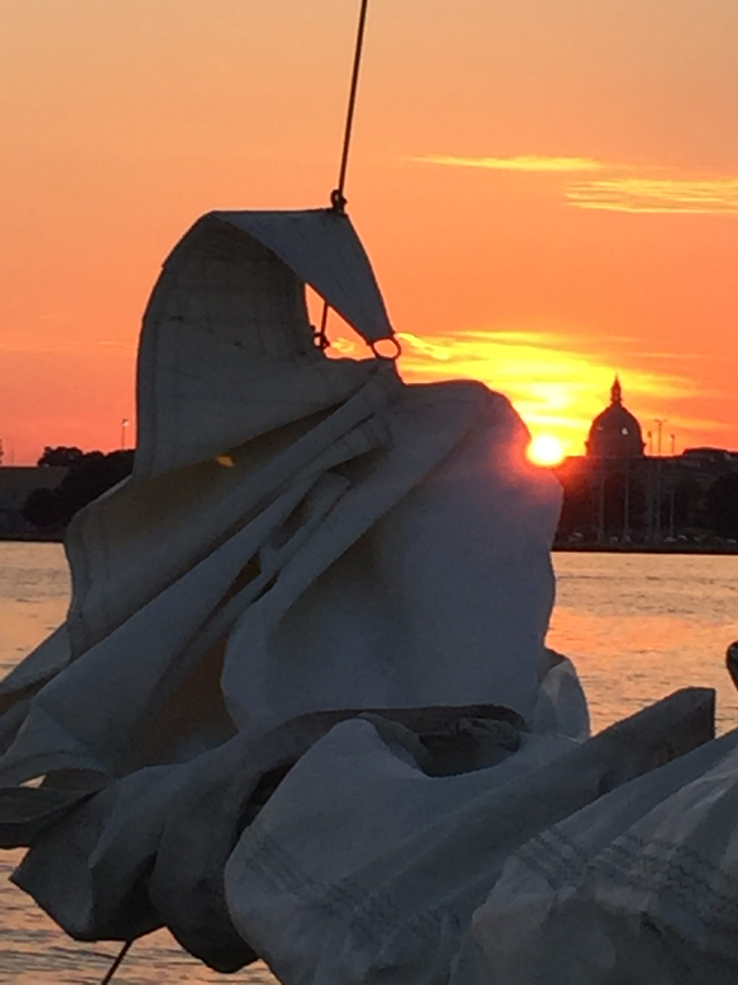 Sails coming down at the end of sunset sail