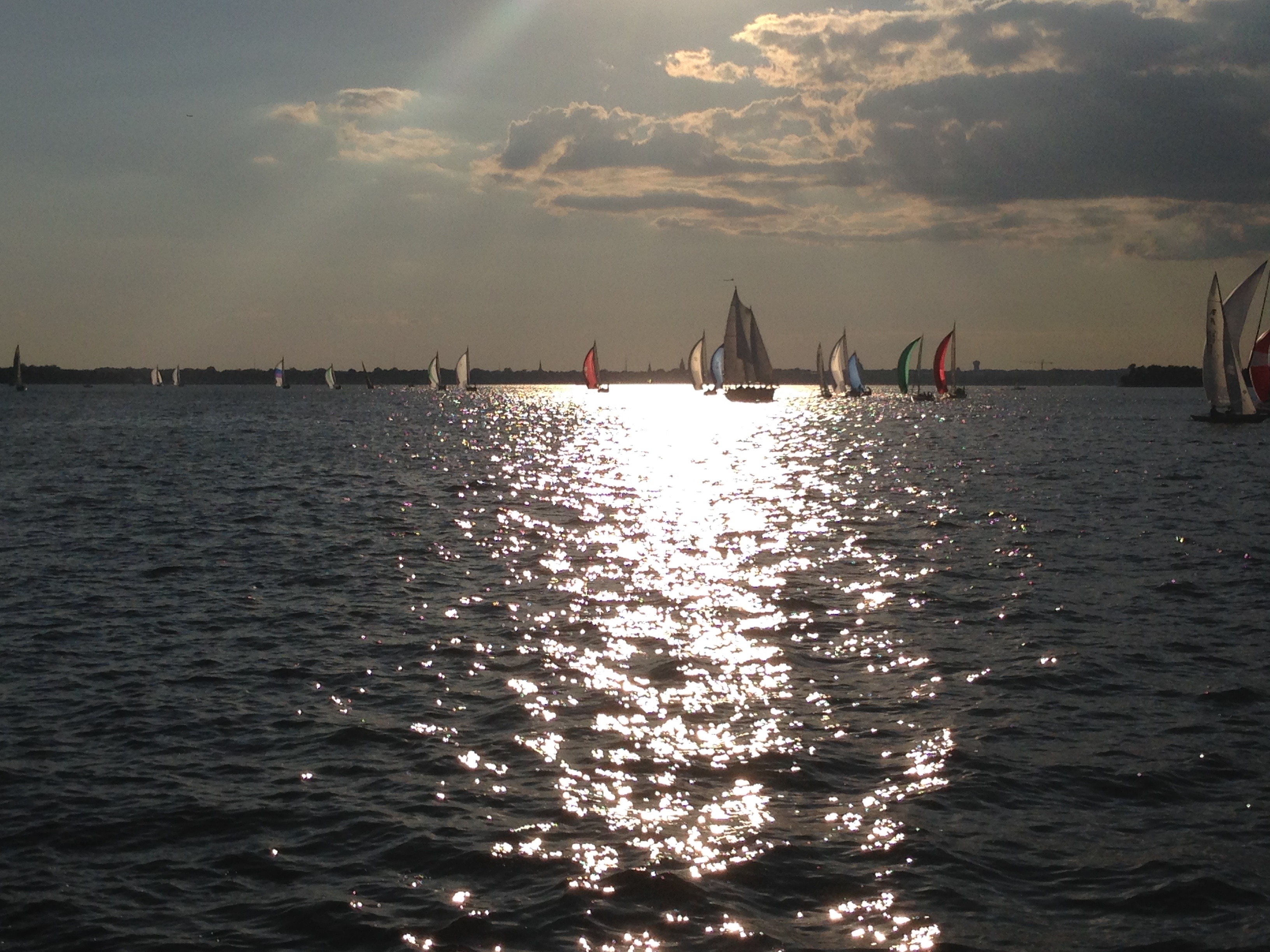 Colorful sailboats racing on Wednesday night at sunset