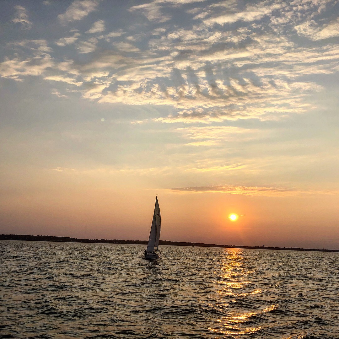 Sailboat framed by a bright yellow sunset on the Chesapeake
