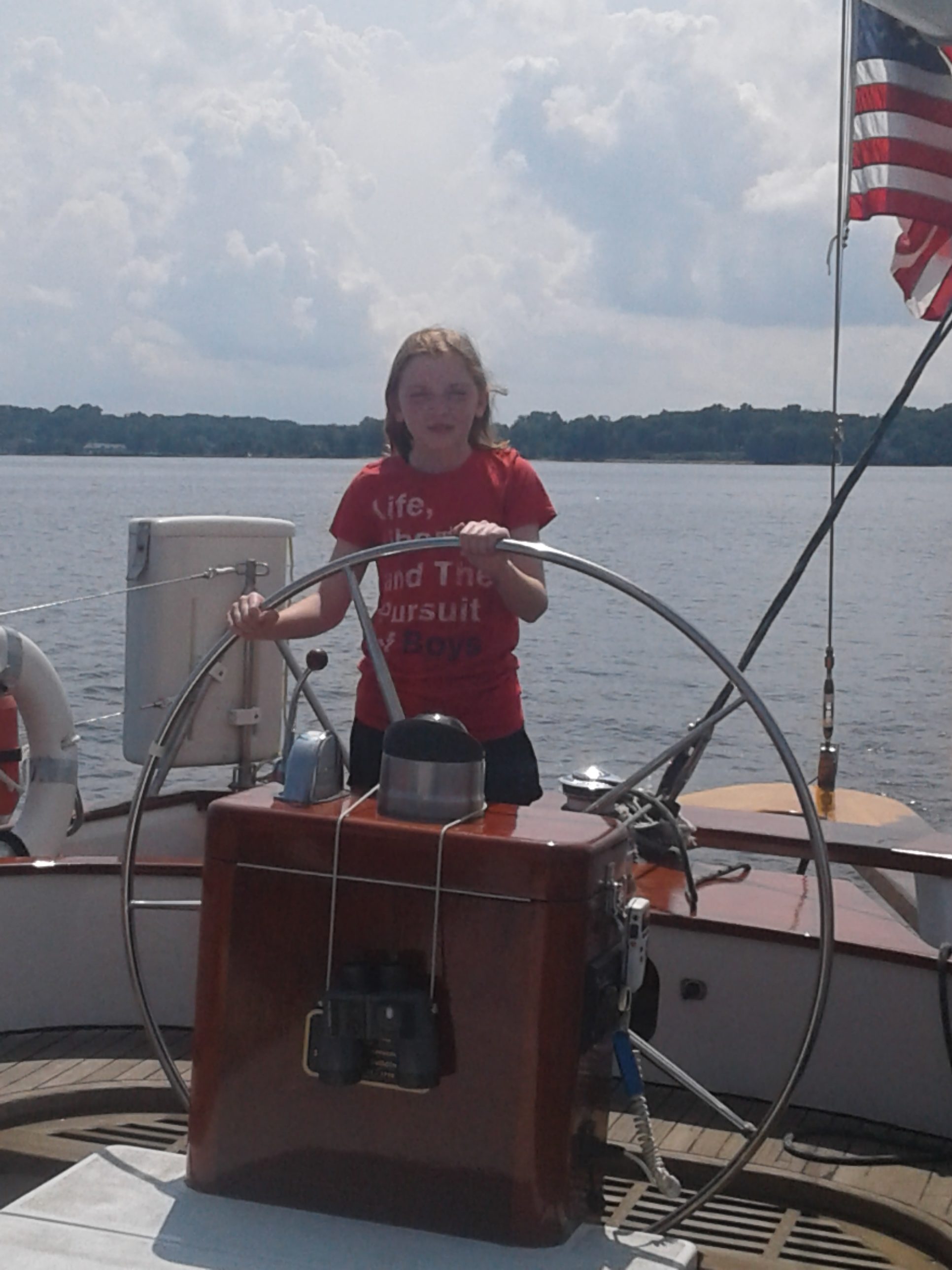 Young lady learning how to steer the boat