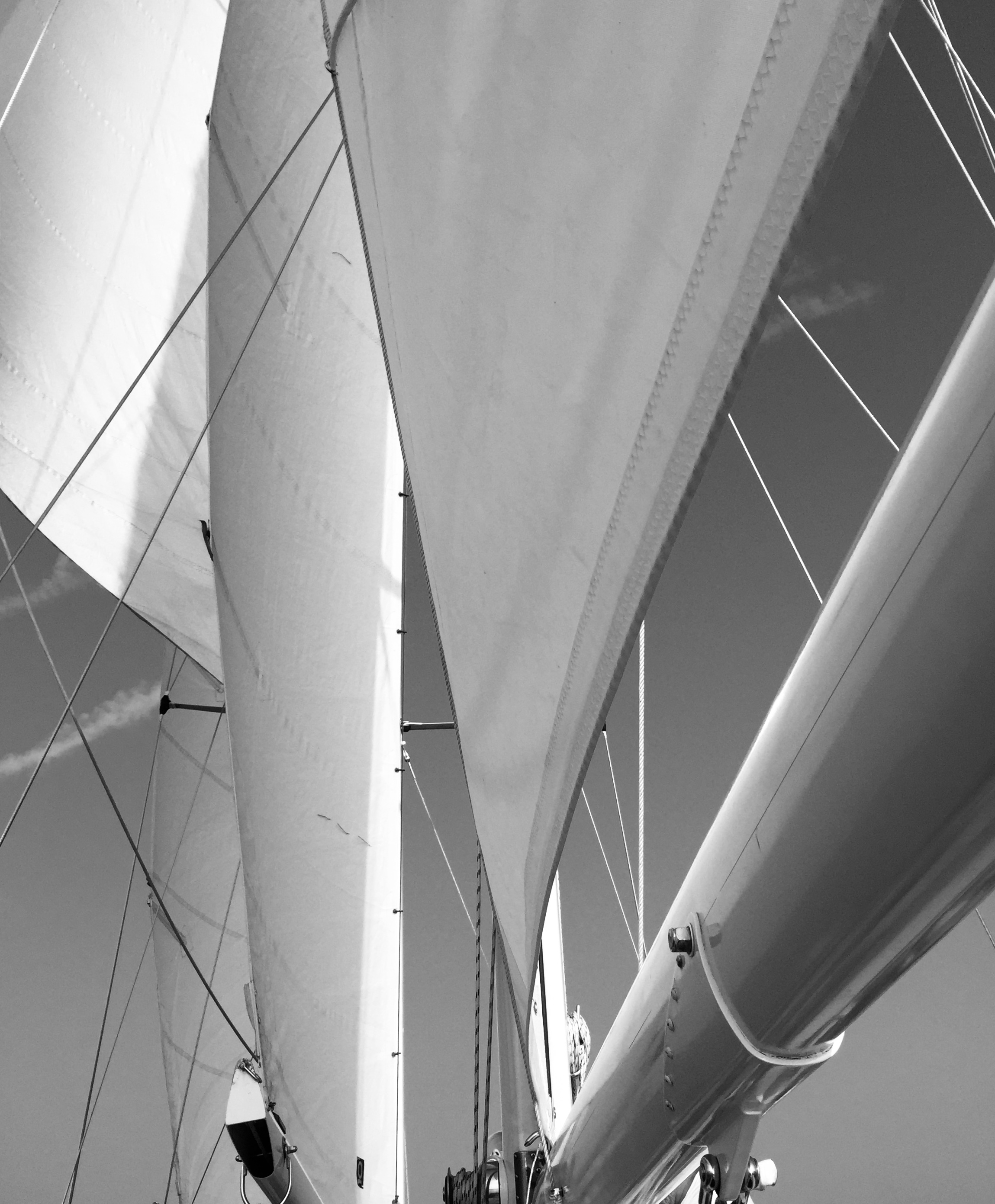 Black and white sails and rigging looking up at the sky