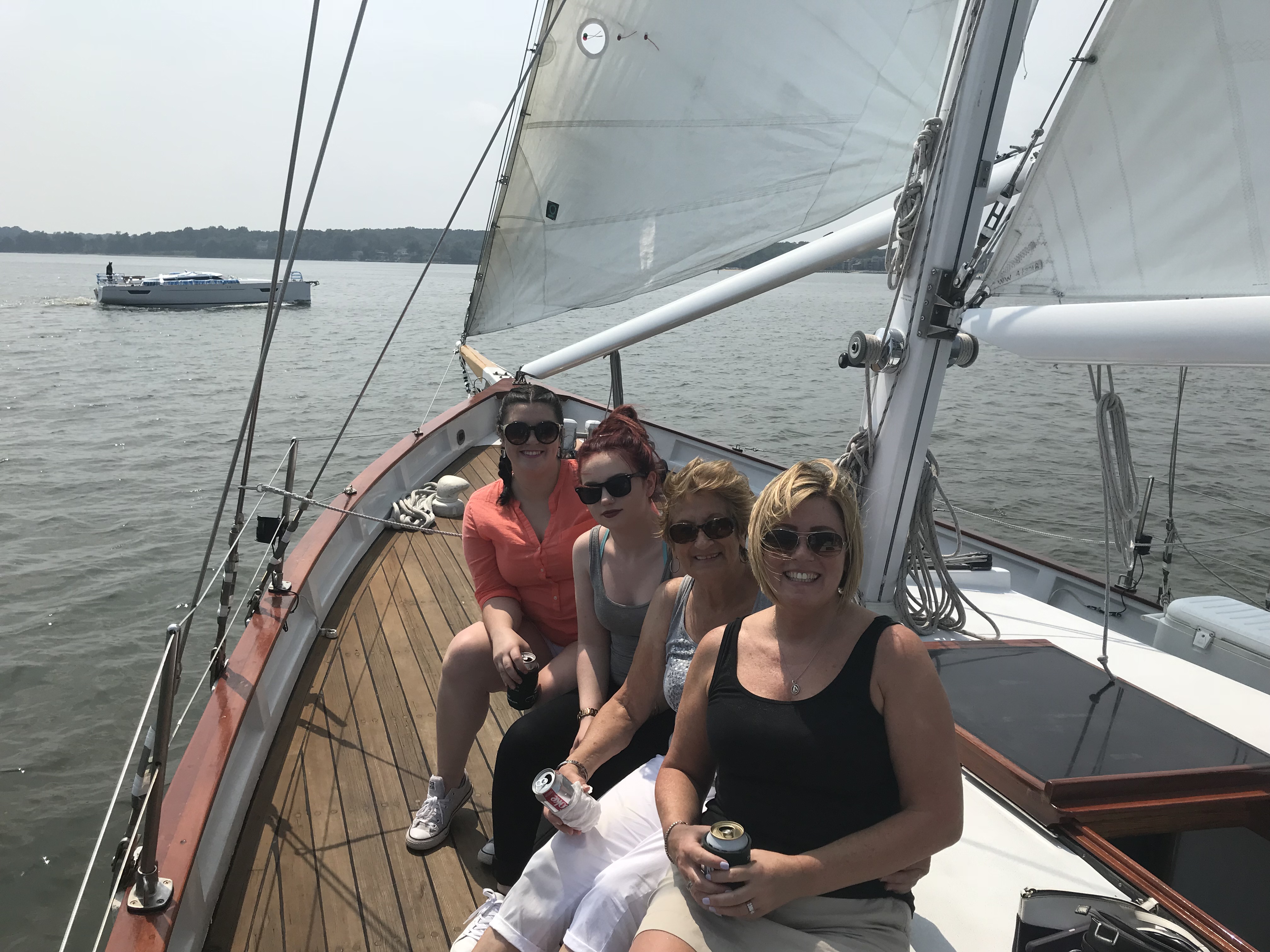Four ladies all smiling and enjoying their sail