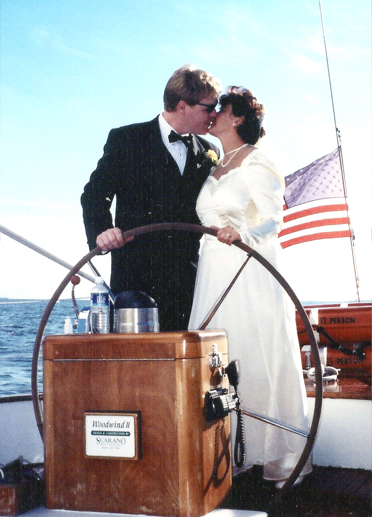 Bride and Groom steering schooner and kissing