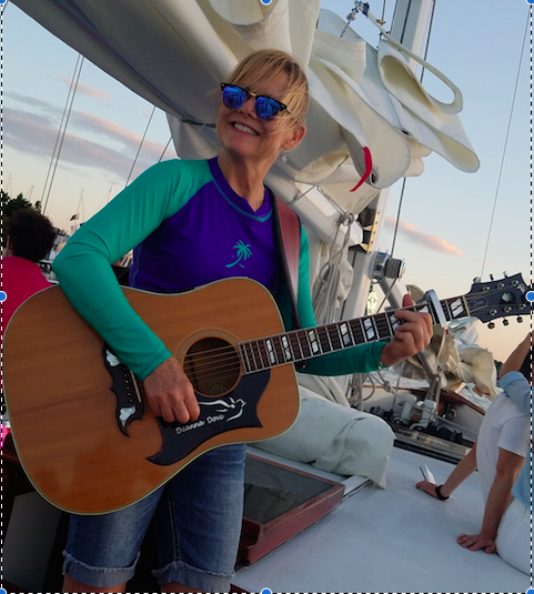 Sunset Sail with Entertainer Deanna Dove playing guitar