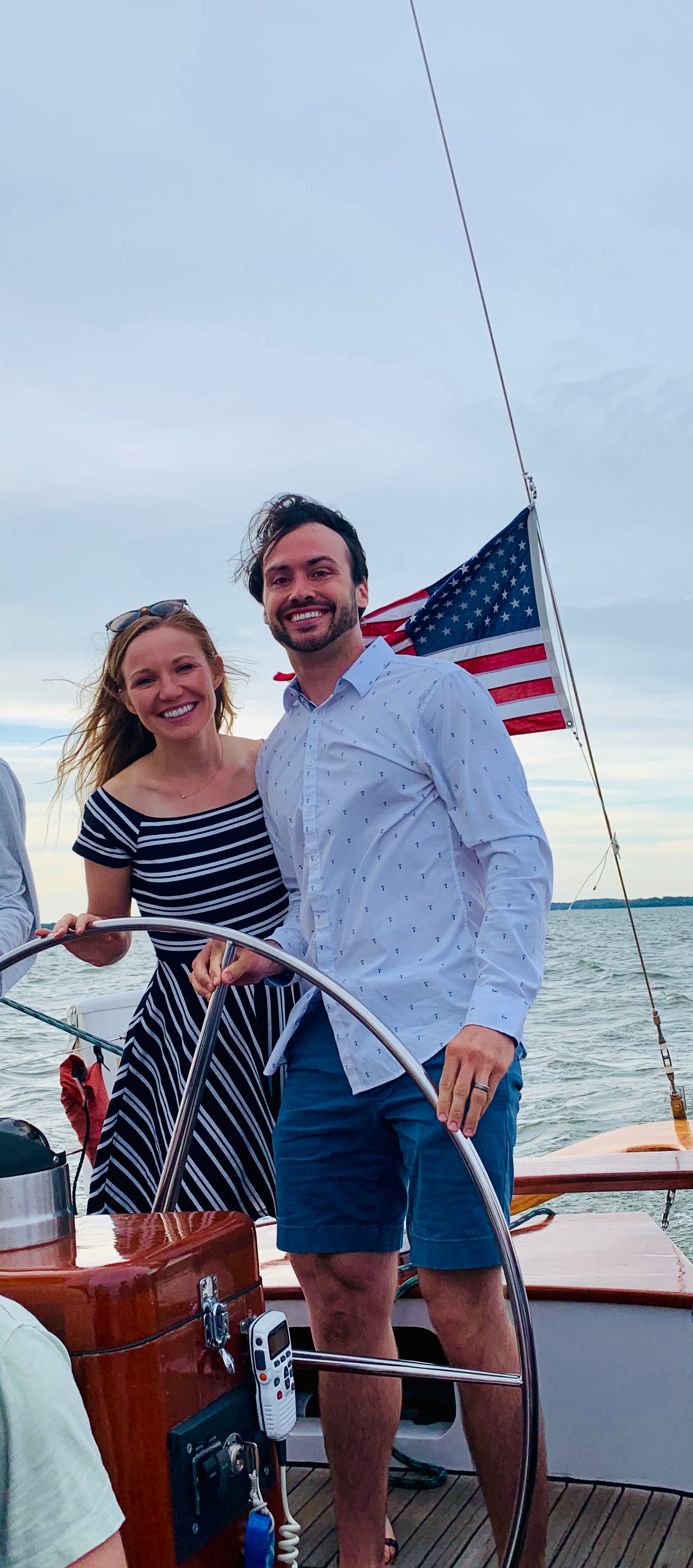 Smiling couple steering the schooner