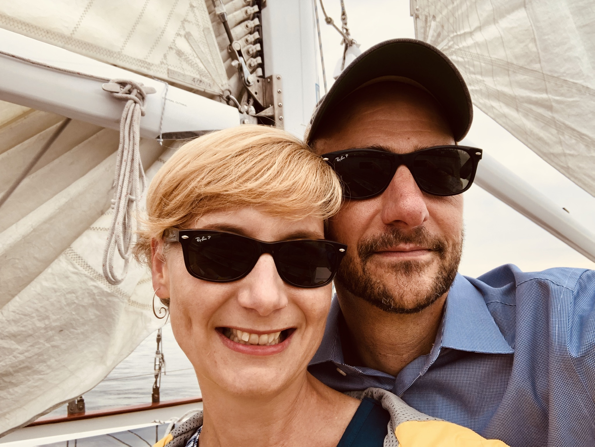 Man and Women with sunglasses enjoying a cruise on the schooner