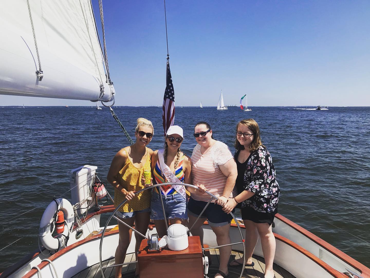 Four ladies steering and celebrating A Sail Before the Veil