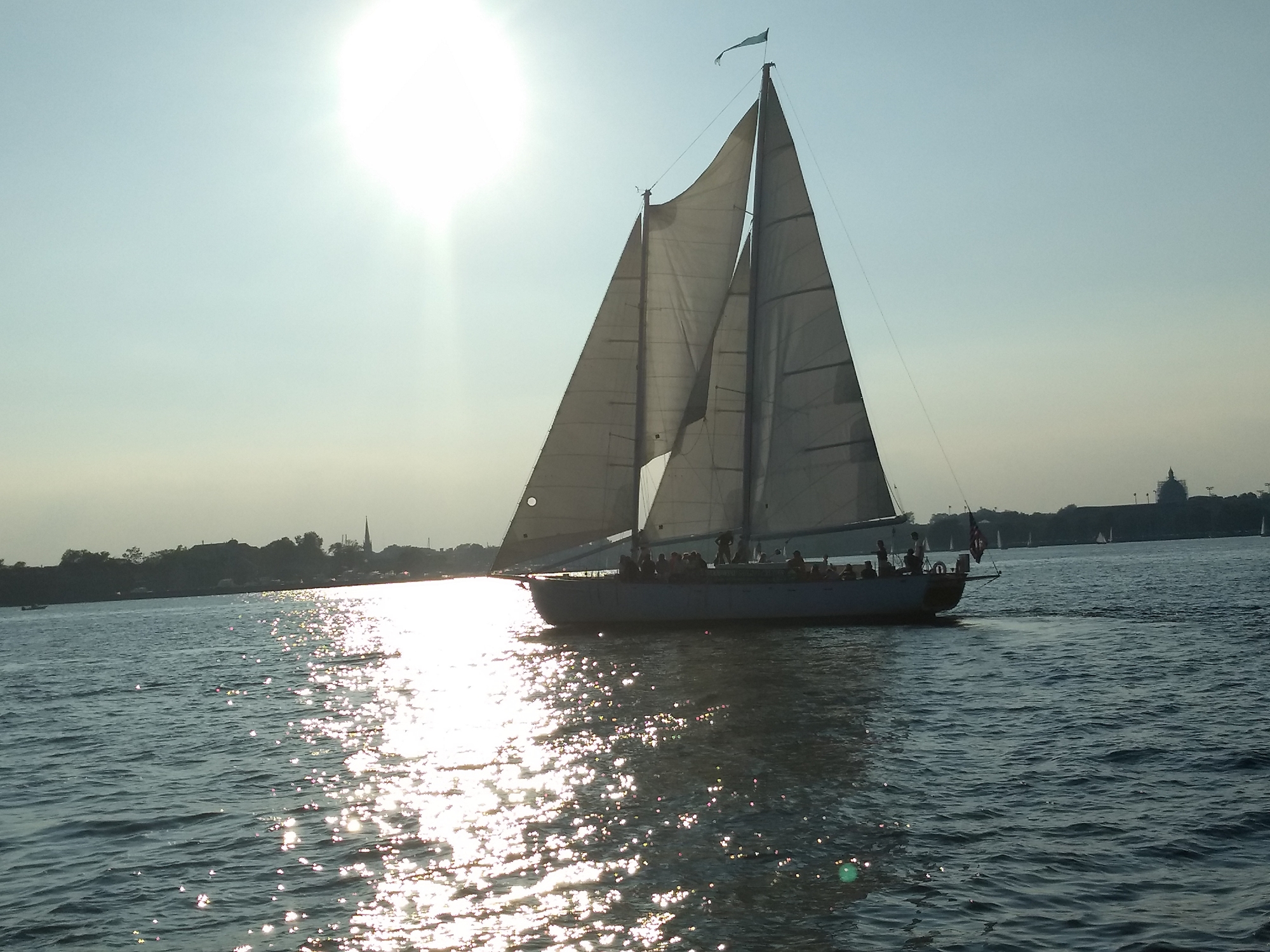 Woodwind II sailing in sun reflecting off of water