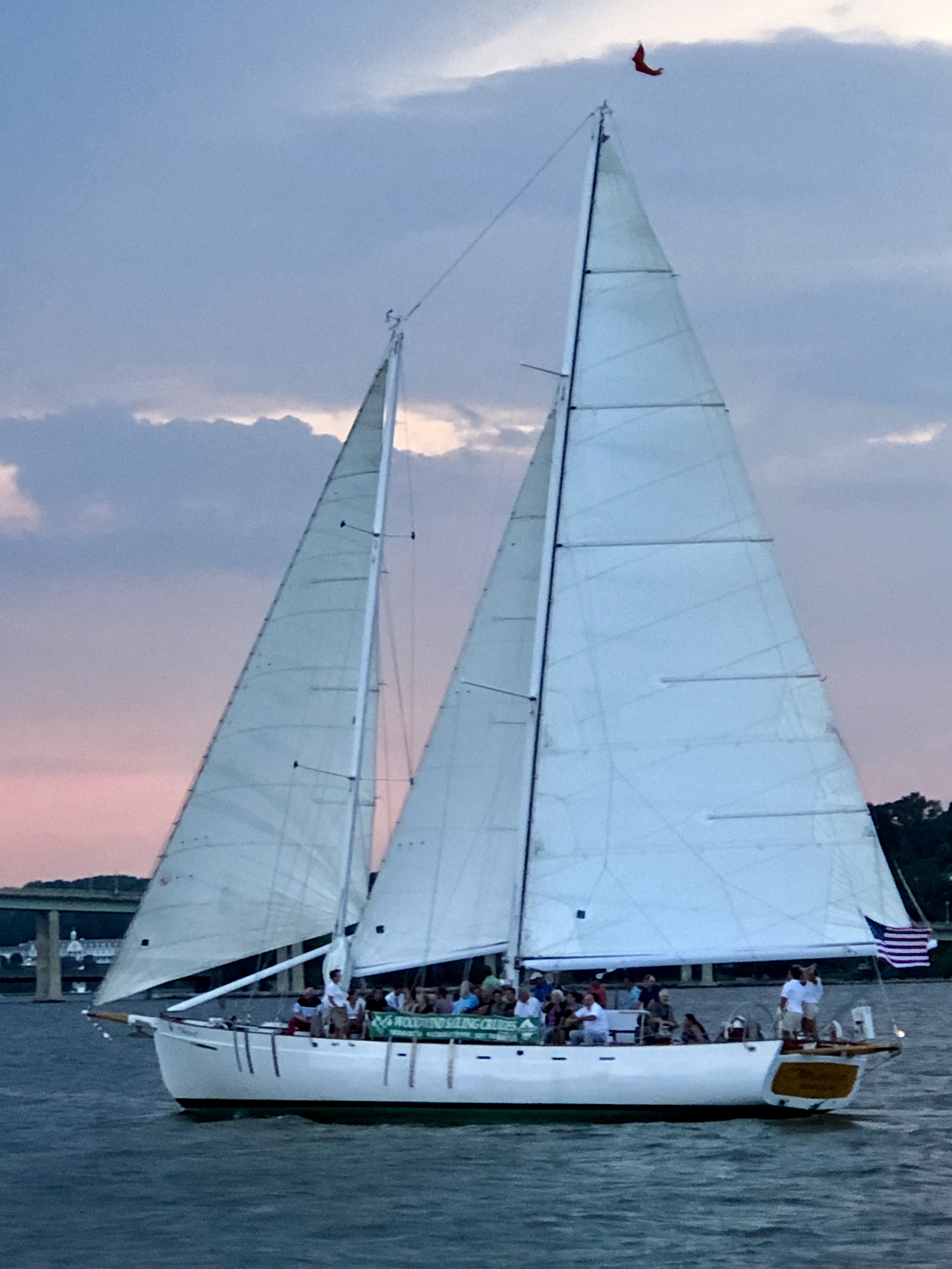 Woodwind schooner sailing at sunset