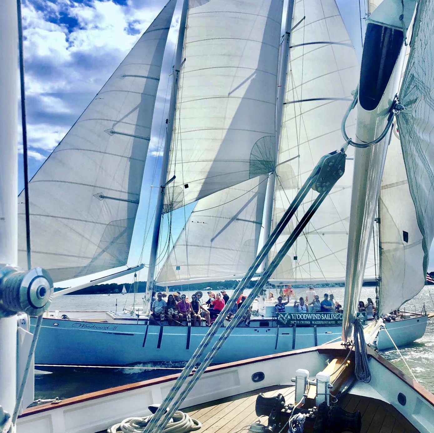 One schooner passing another schooner with guests waving