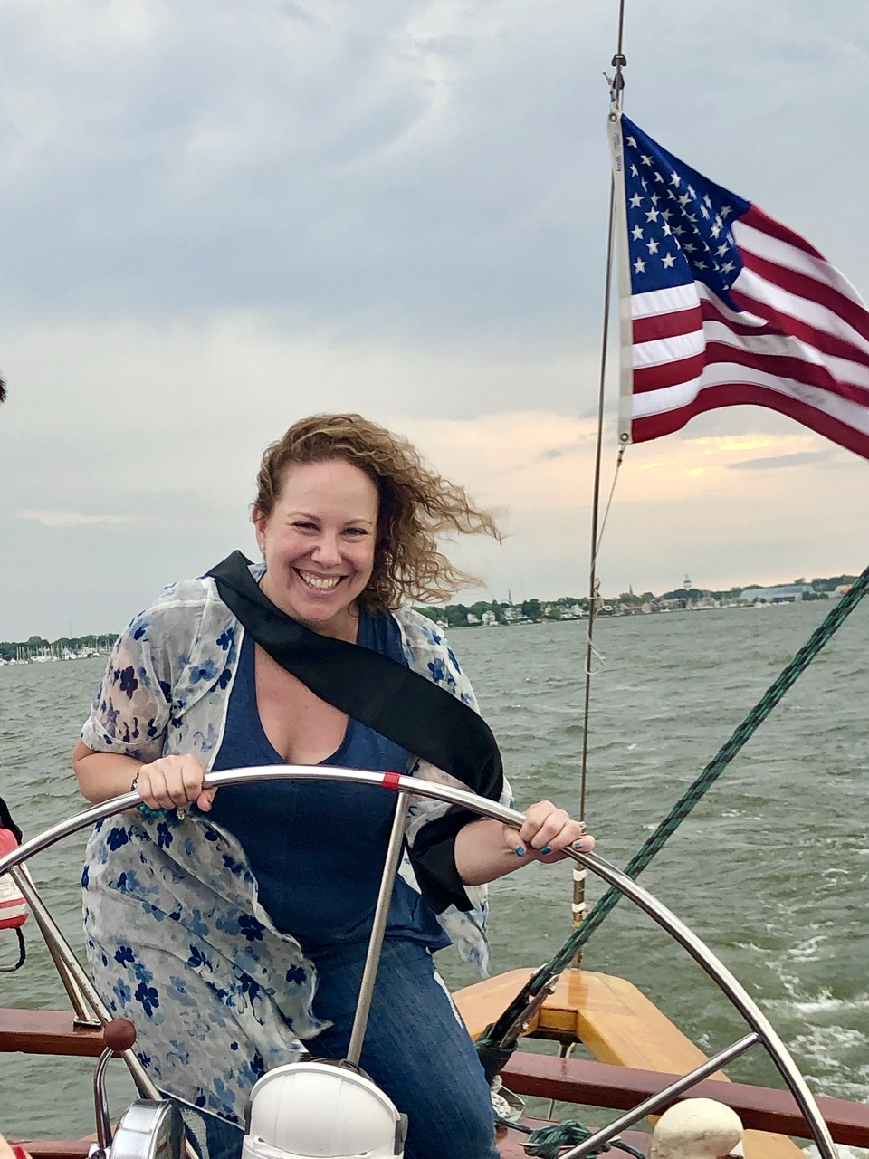 Women steering the helm and smiling on her 40th Birthday