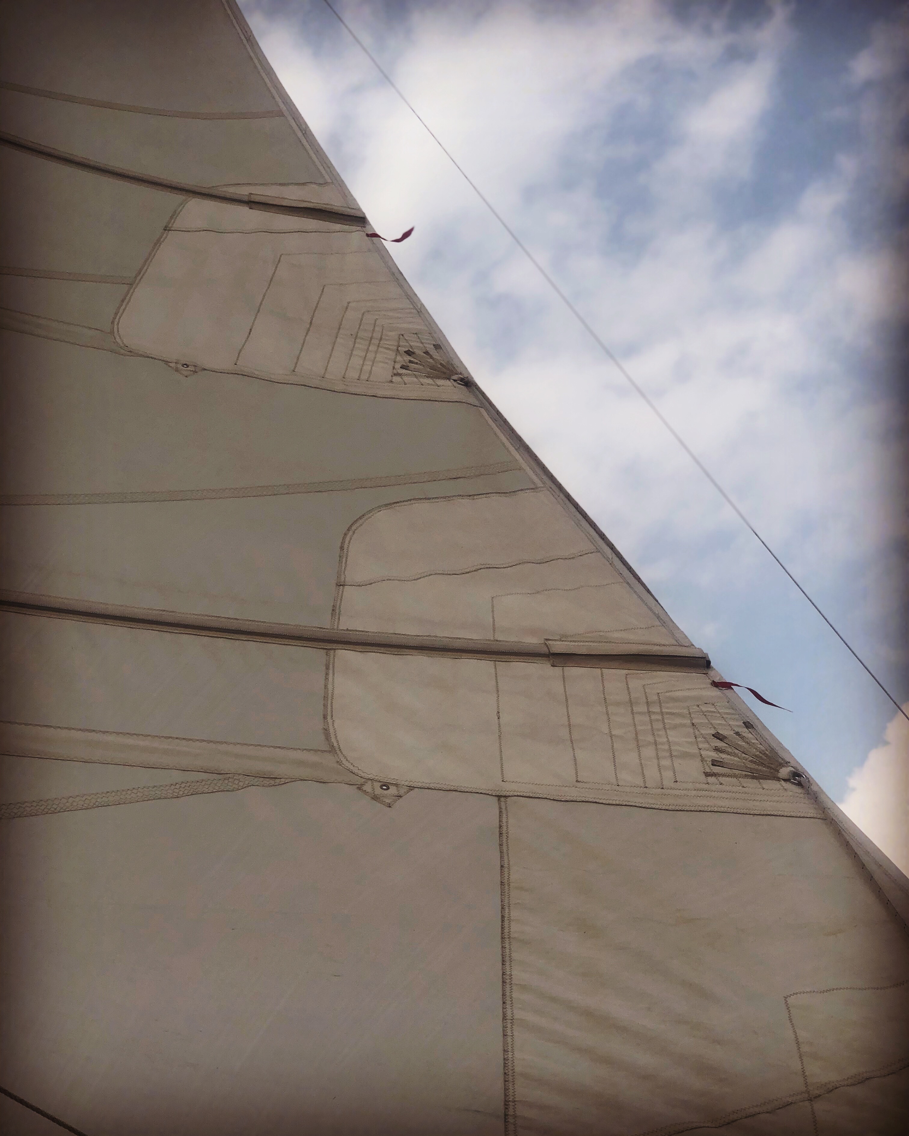 Schooner sail and blue sky with white clouds