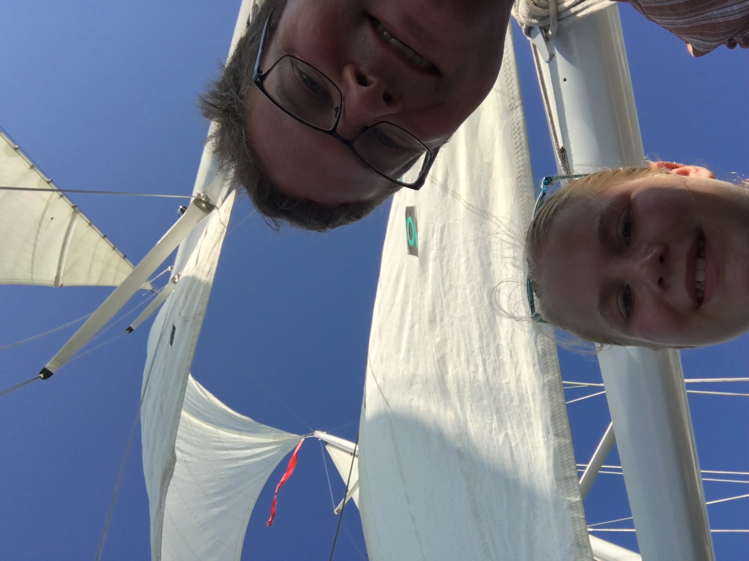 Two guests taking selfie with white sails and blue skies above