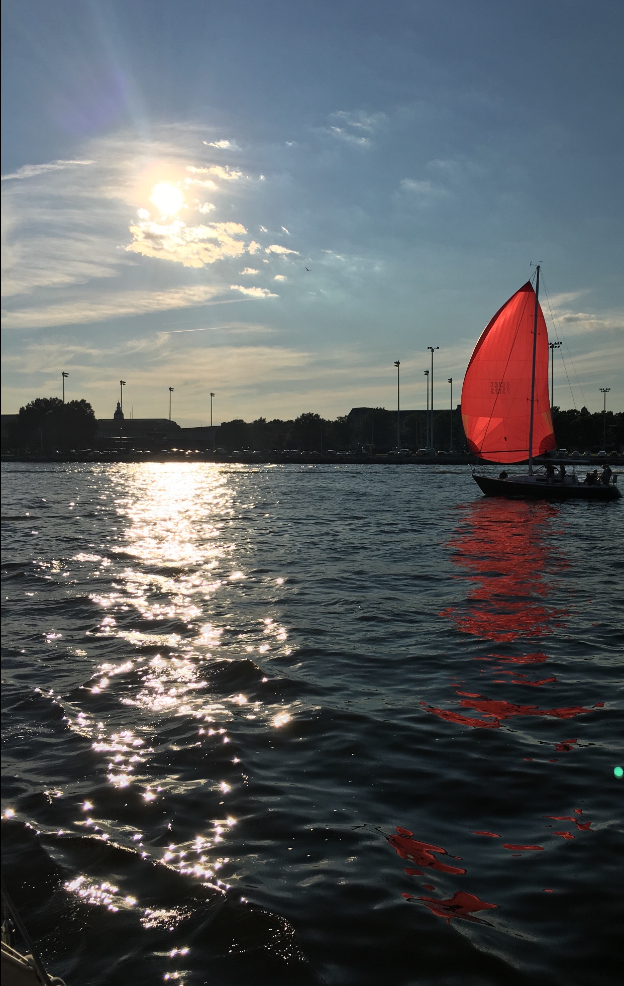 Red sail on a sailboat at sunset